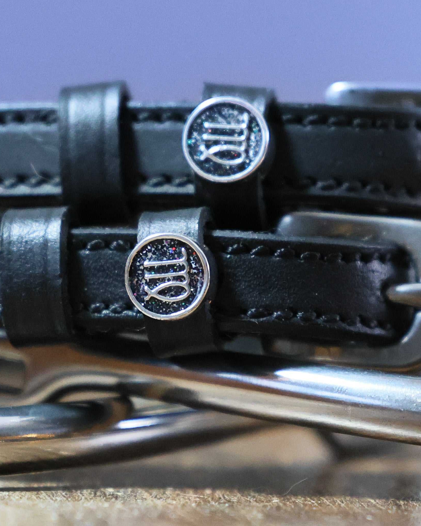 Black leather Virgo Spur Straps with stainless steel buckles and custom zodiac charm
