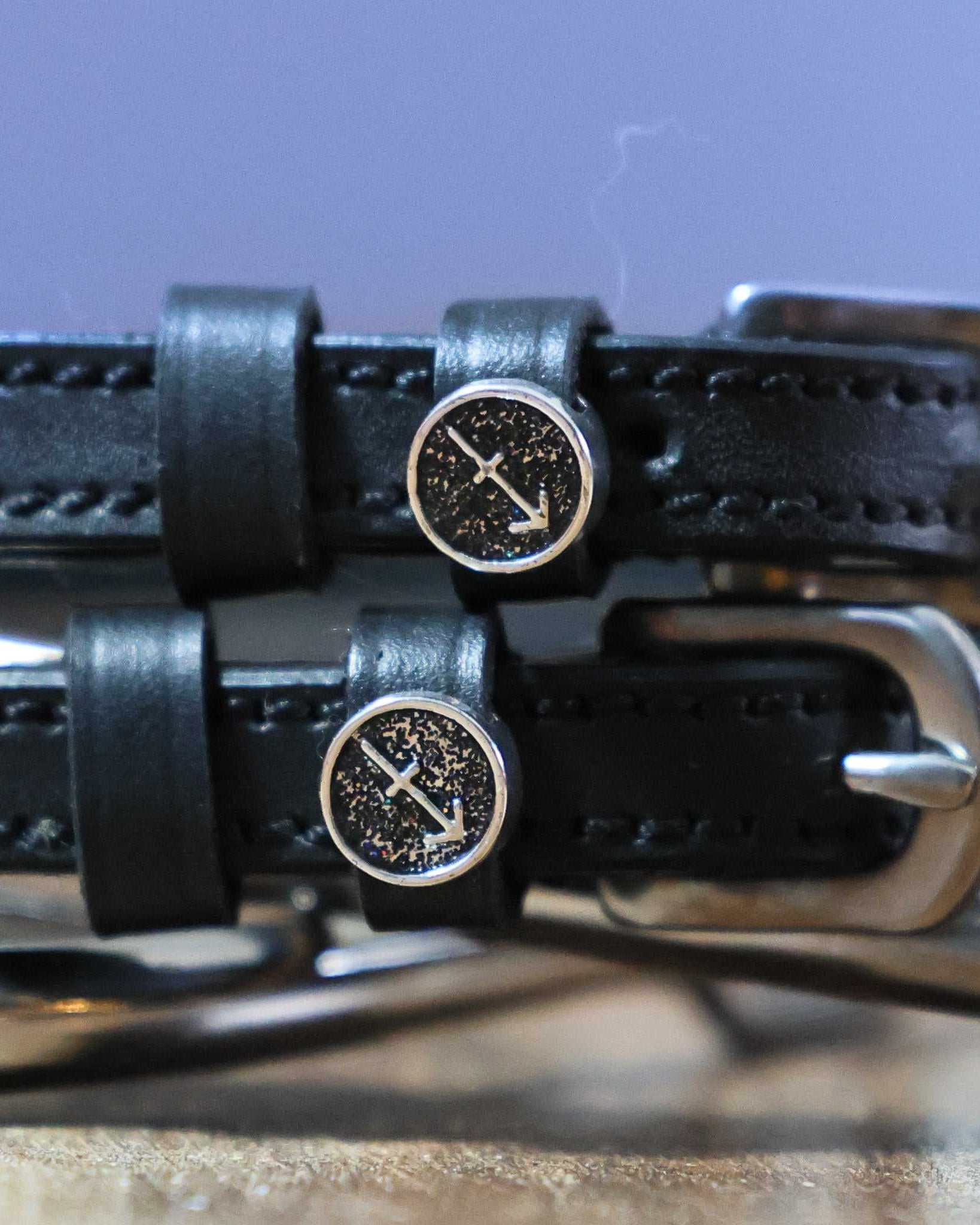 Black leather Sagittarius Spur Straps with stainless steel buckles and custom arrow charm