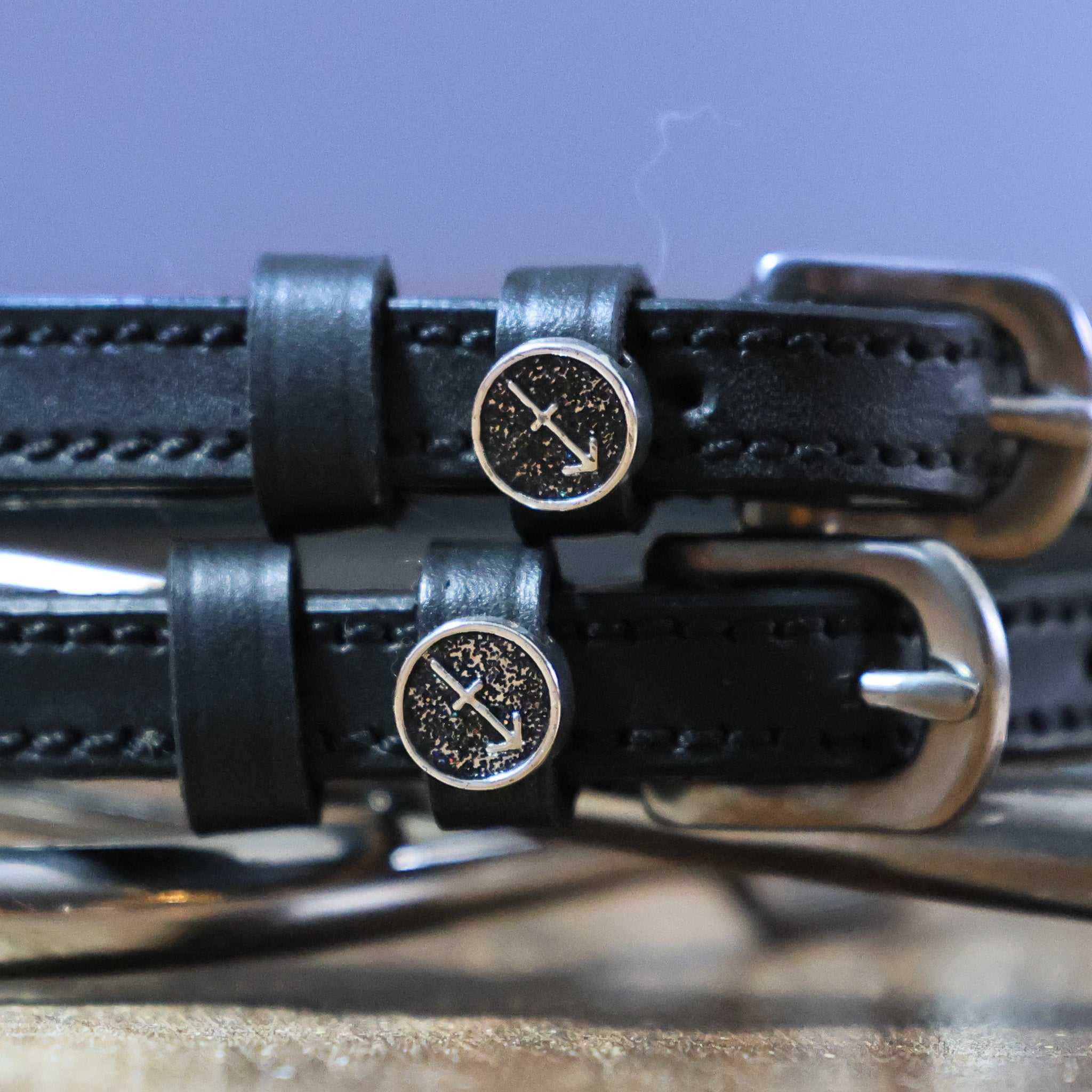 Black leather Sagittarius Spur Straps with stainless steel buckles and custom arrow charm
