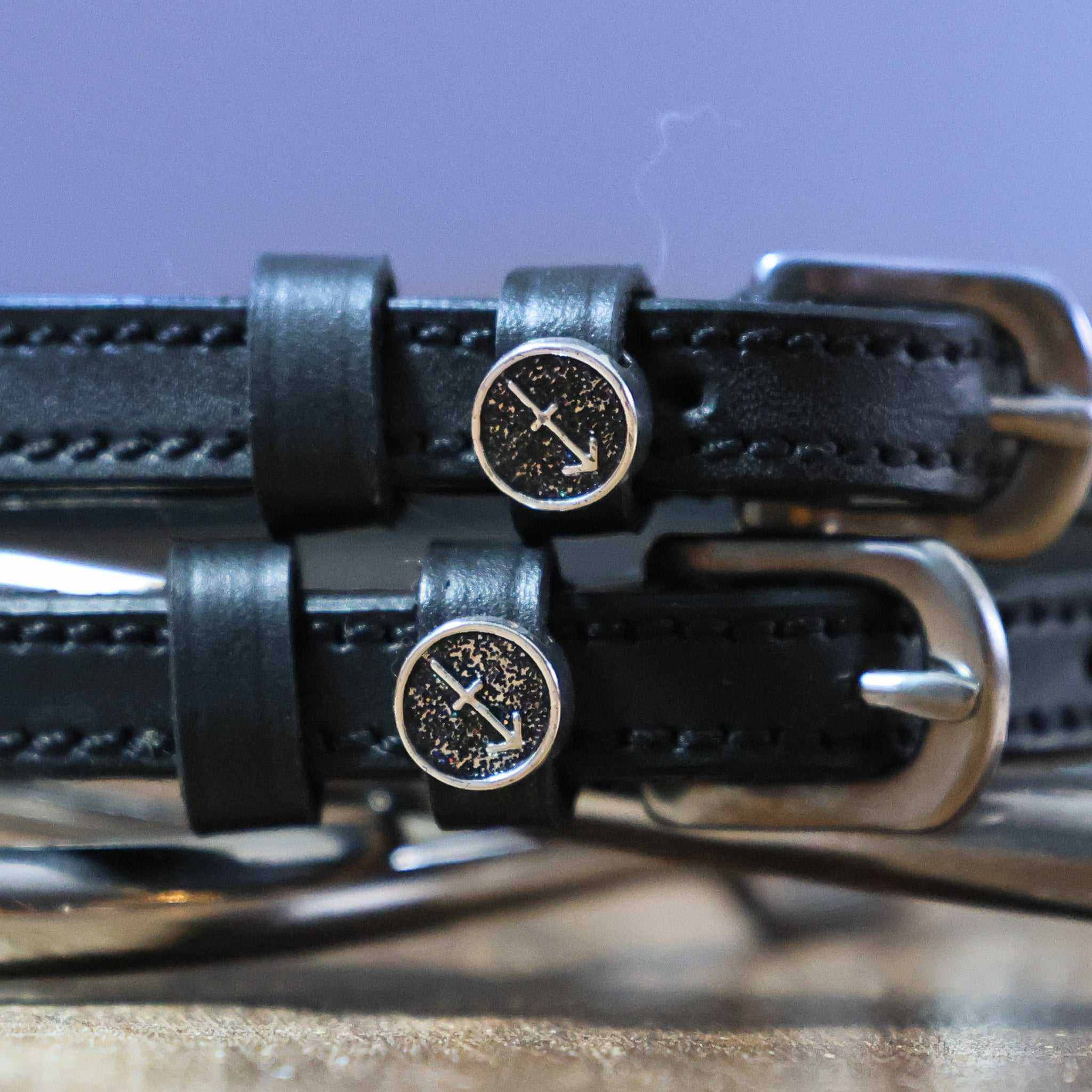 Black leather Sagittarius Spur Straps with stainless steel buckles and custom arrow charm