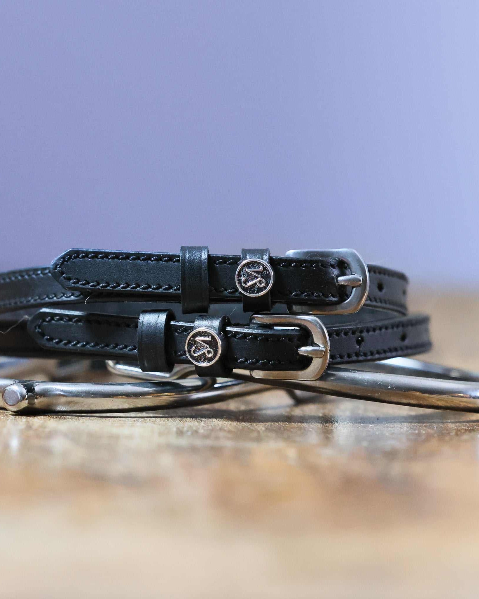 Black leather Capricorn Spur Straps with stainless steel buckle and custom charm by ManeJane