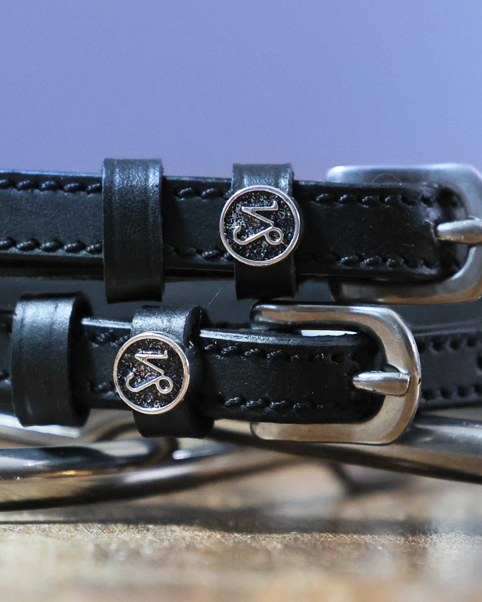 Black leather Capricorn Spur Straps with stainless steel buckles and custom Capricorn charms