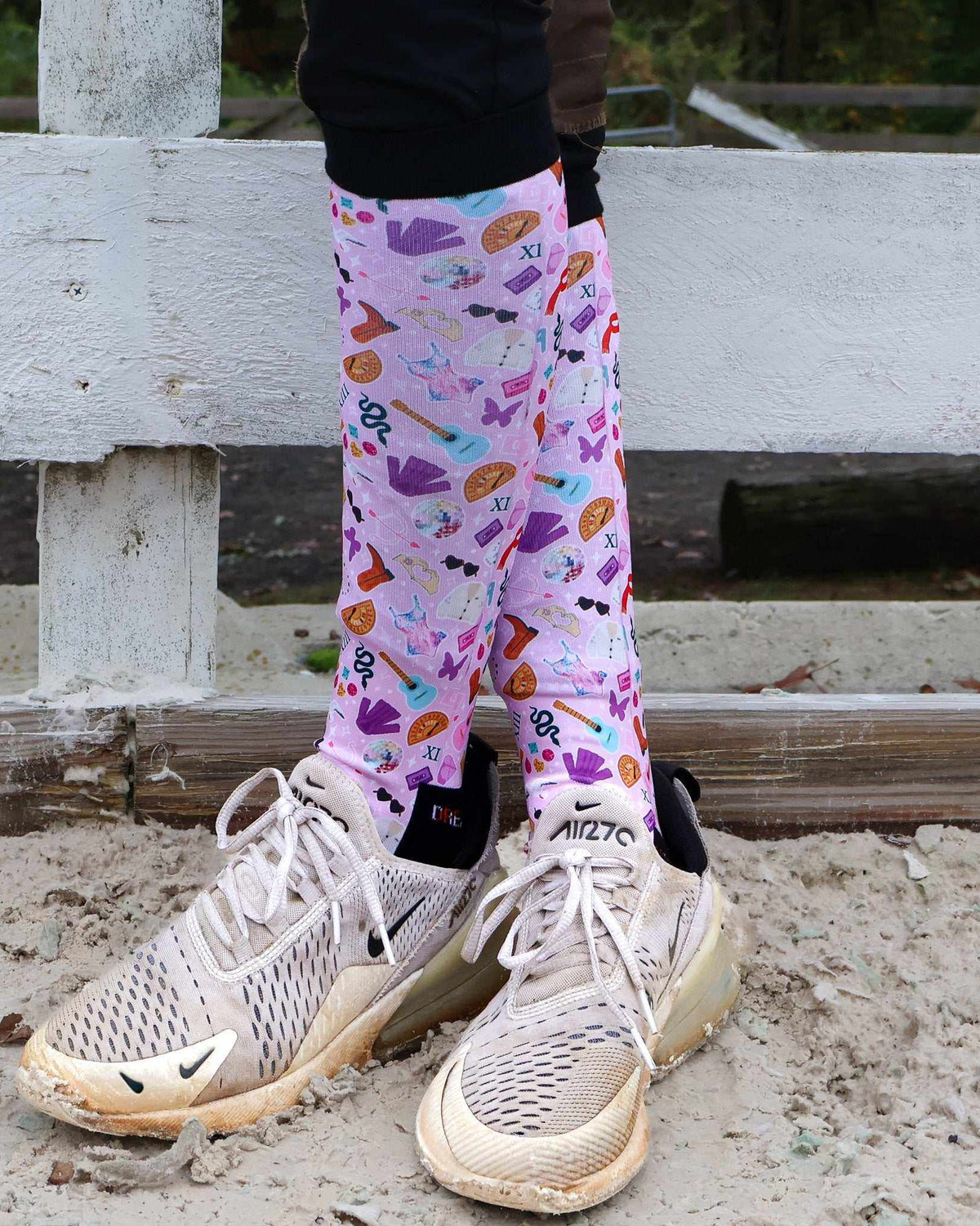 Limited edition colorful boot socks with unique prints worn with sneakers outdoors