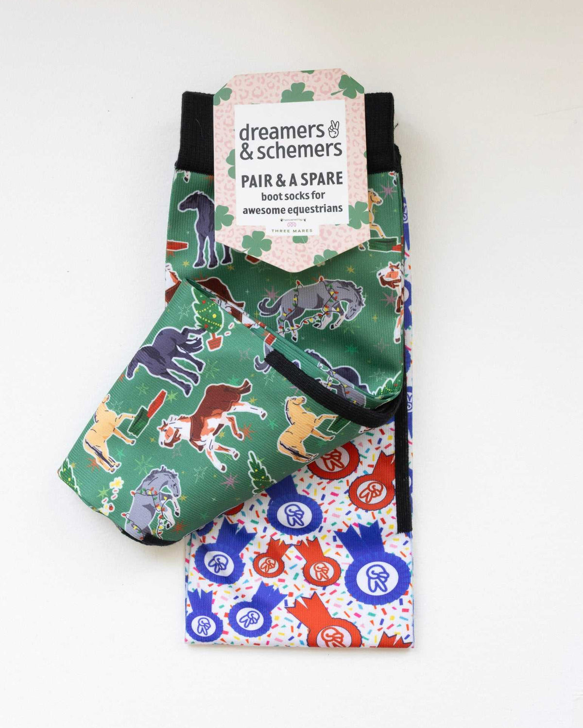 The Naughty List boot socks shown folded with the included spare sock and printed cuff detail