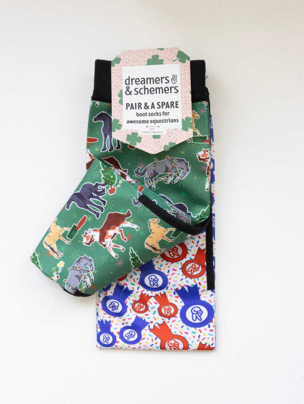 The Naughty List youth boot socks shown folded with the included spare sock and patterned cuff