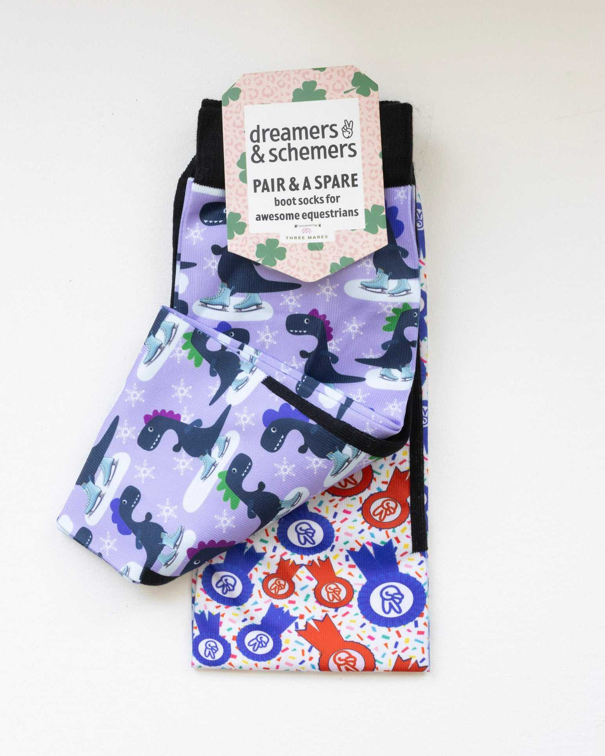 Dino-skate boot socks shown folded with the included spare sock and printed cuff detail