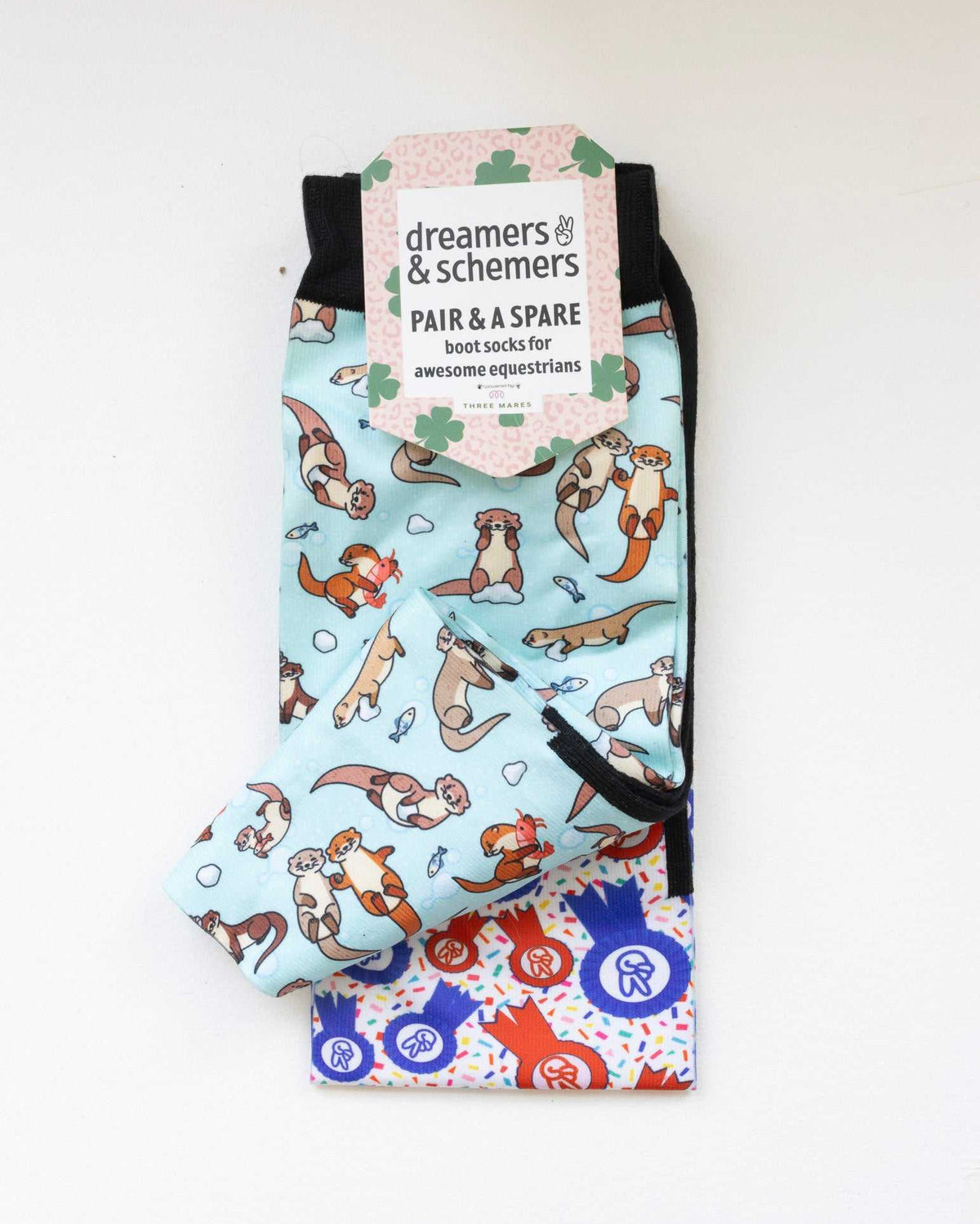 Otter-ly Adorable boot socks shown folded with the included spare sock and printed cuff detail