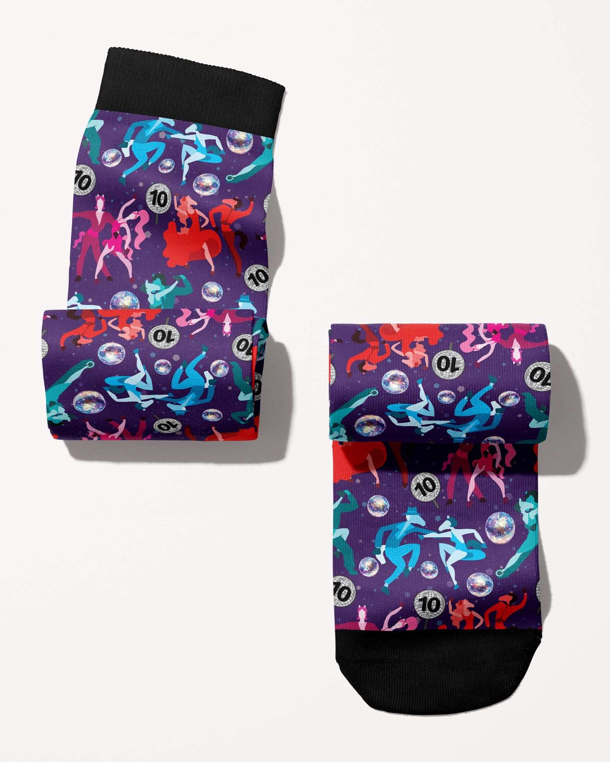 Prancing with the Stars Limited Edition boot socks, dancing couples and disco balls on deep purple, rolled, showing the pattern repeat, by Dreamers & Schemers