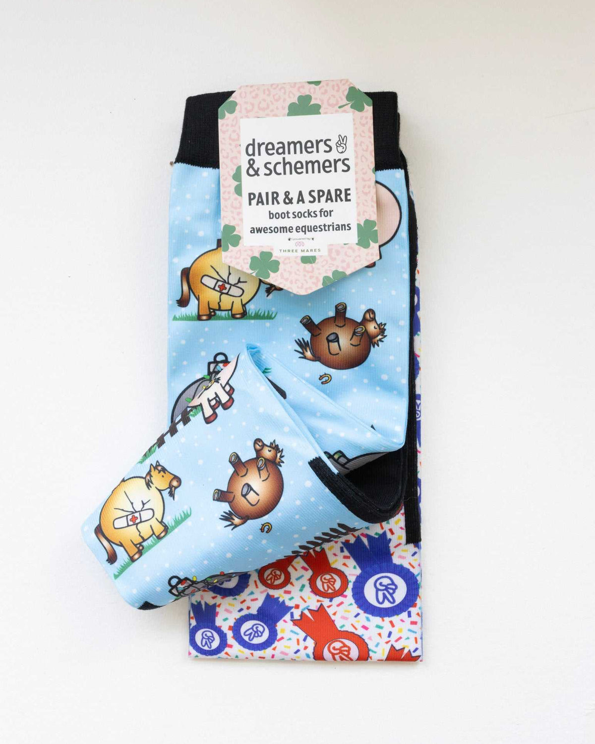 Pasture Ornaments boot socks shown folded with the included spare sock and printed cuff detail