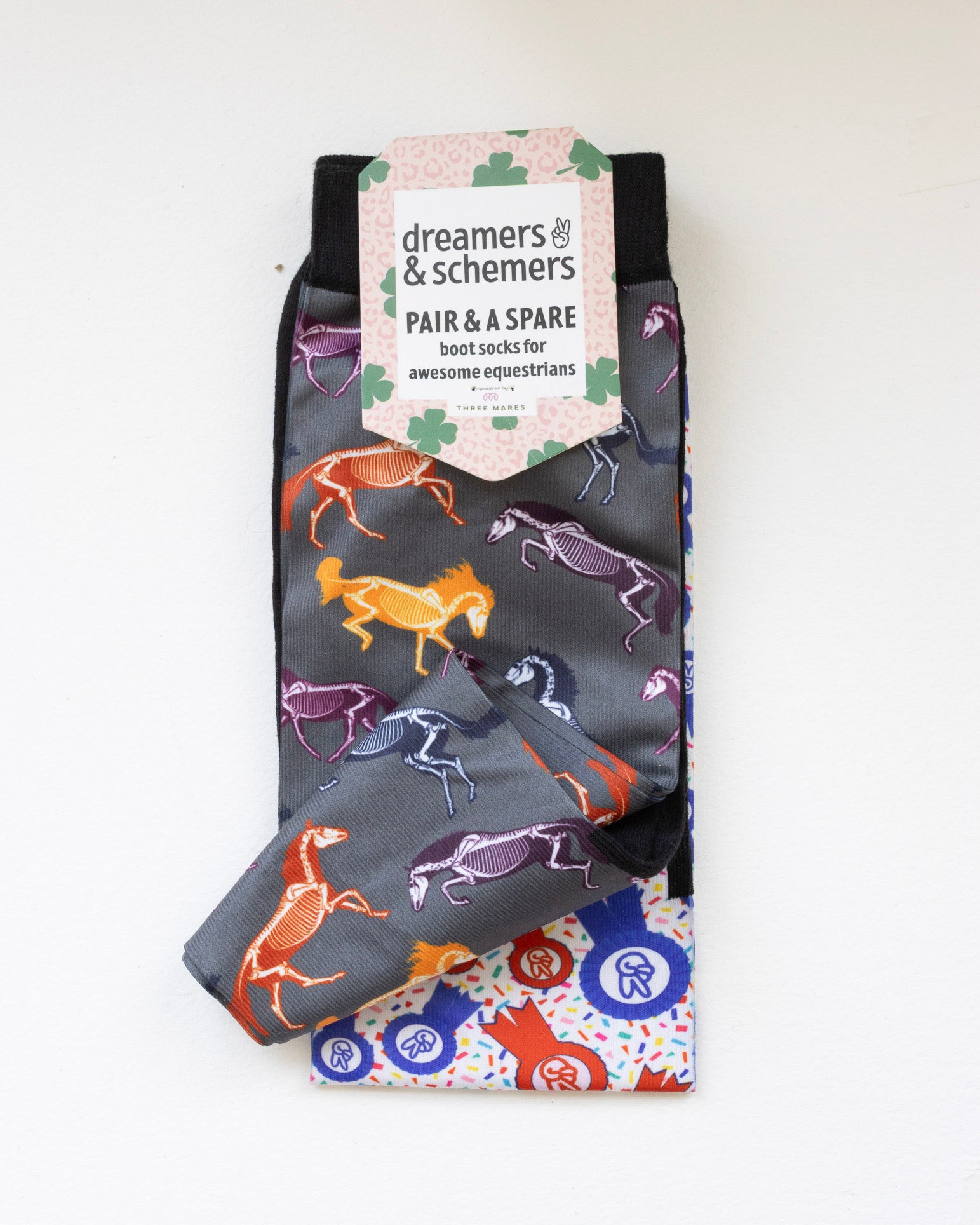 The Pony Island Horse Skeletons boot socks shown folded with the included spare sock and printed cuff detail