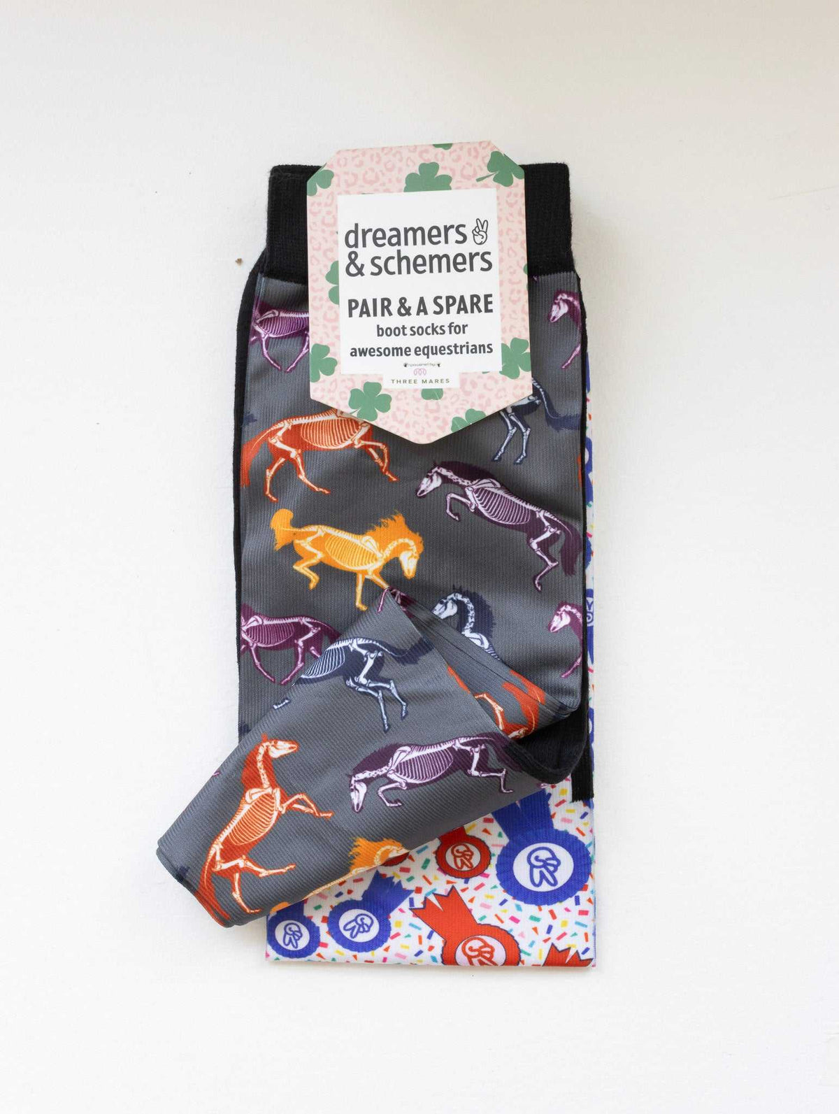 The Pony Island Horse Skeletons boot socks shown folded with the included spare sock and printed cuff detail