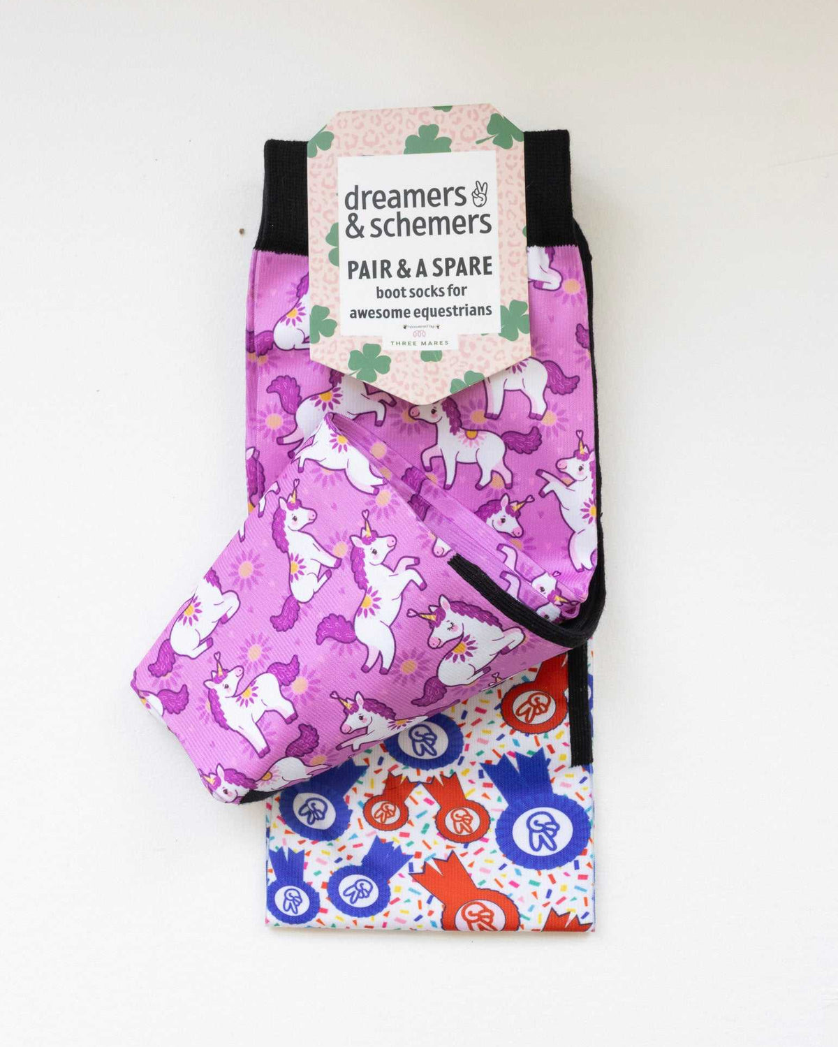 Sunshine and Unicorns boot socks shown folded with the included spare sock and printed cuff detail