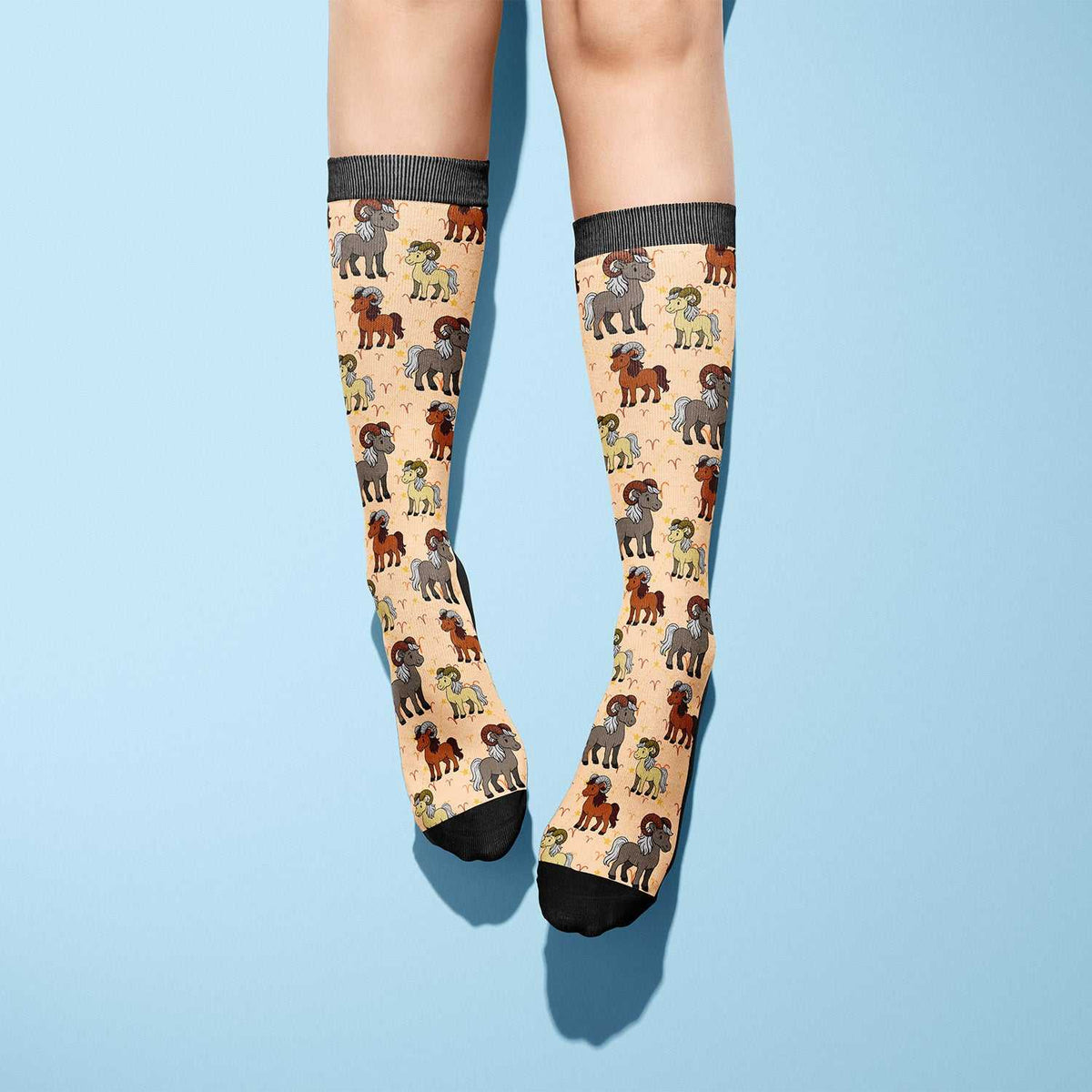 Aries zodiac themed boot socks in beige with black toes and ram illustrations, made in the USA