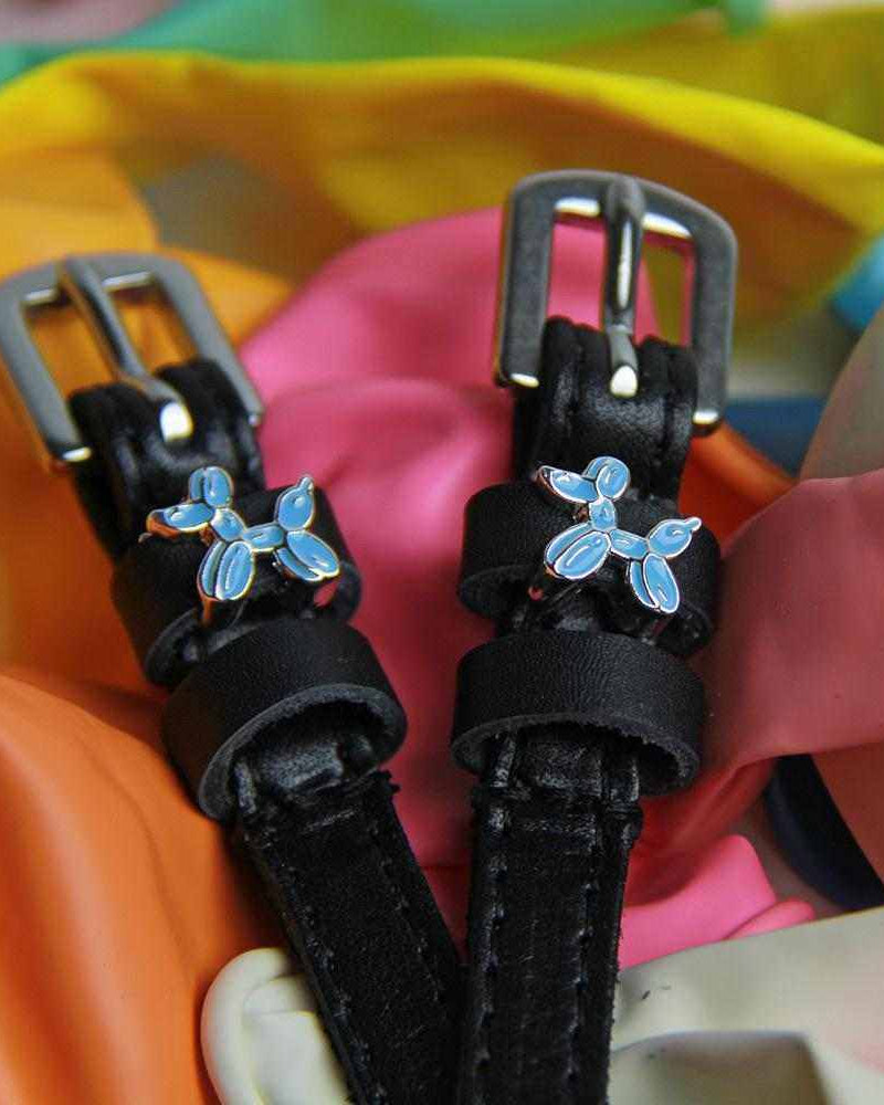 Balloon dog spur straps displayed on a bed of colorful balloons