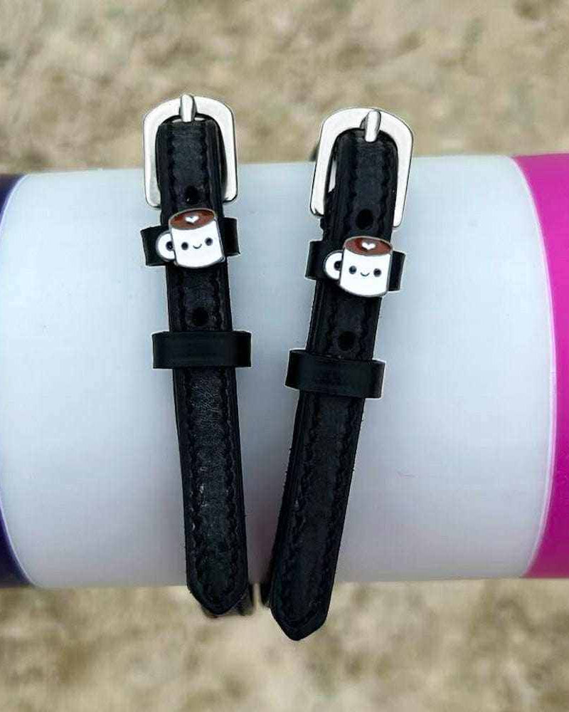 ManeJane coffee-mug spur straps wrapped around a white bottle outdoors