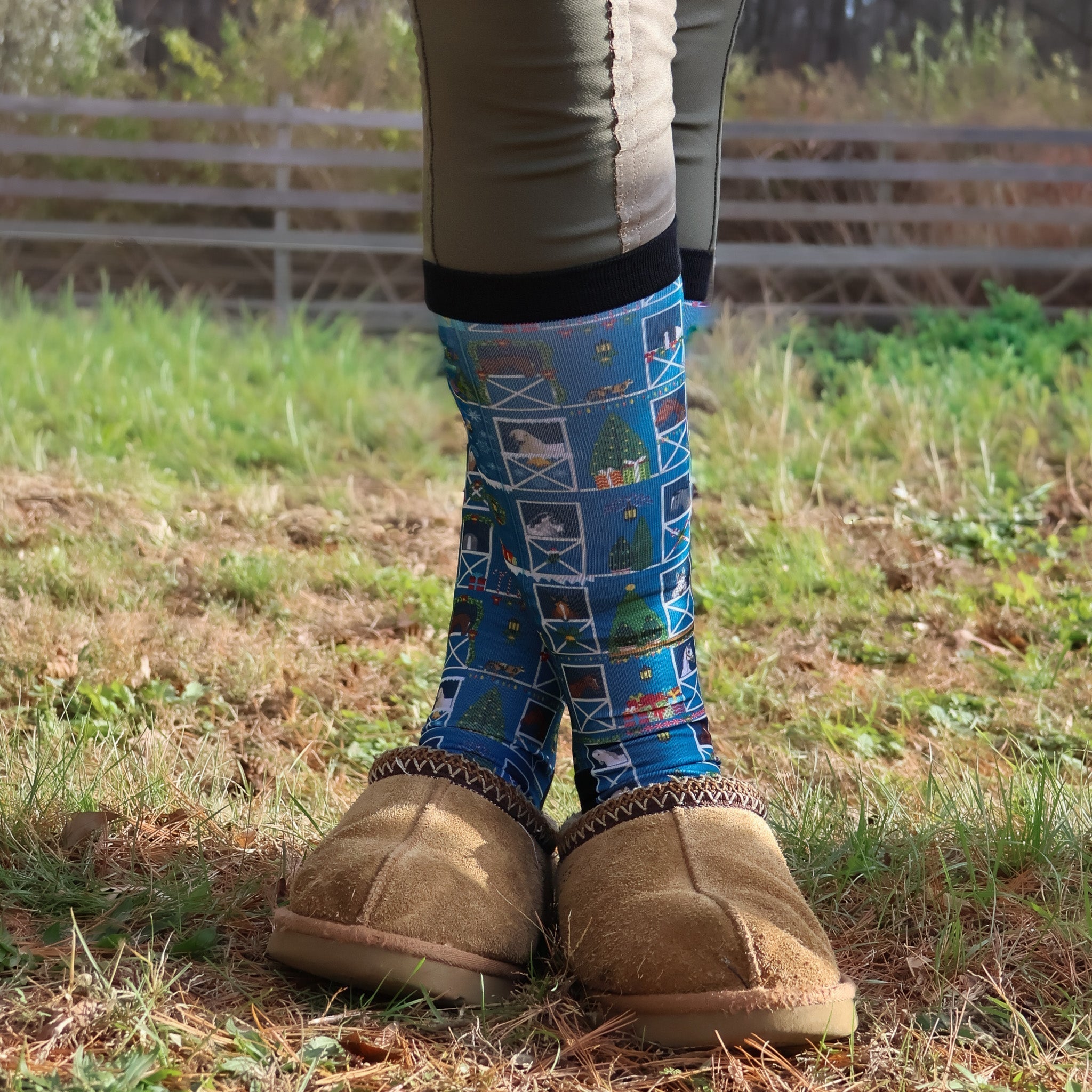 Limited Edition Pony Island Holiday Barn Socks with festive pony and barn designs worn with cozy slippers outdoors