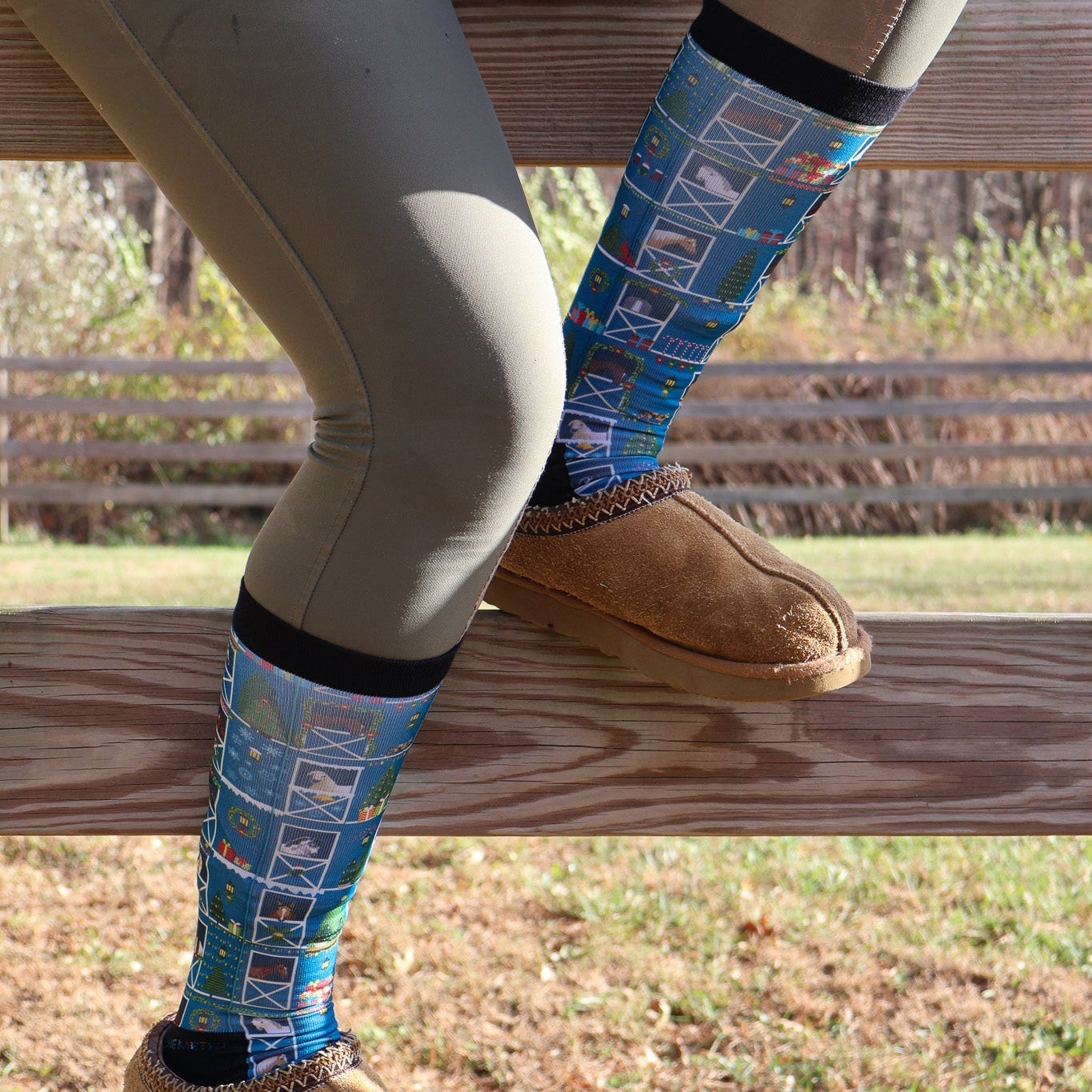 Limited Edition Pony Island Holiday Barn Socks with festive pony and garland design worn with slippers outdoors