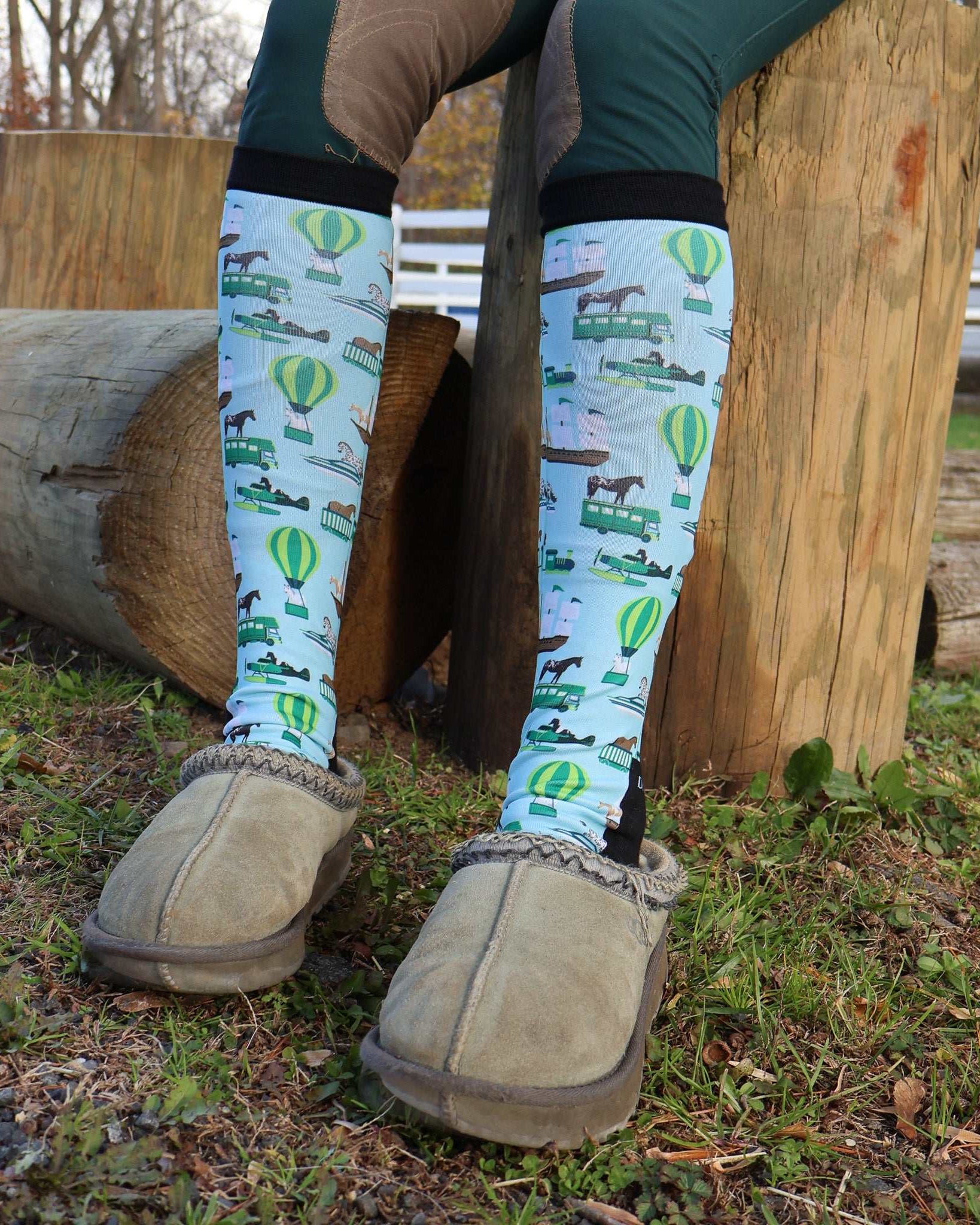 Limited Edition Pony Island Pony Transport Socks with pony and hot air balloon design on legs outdoors