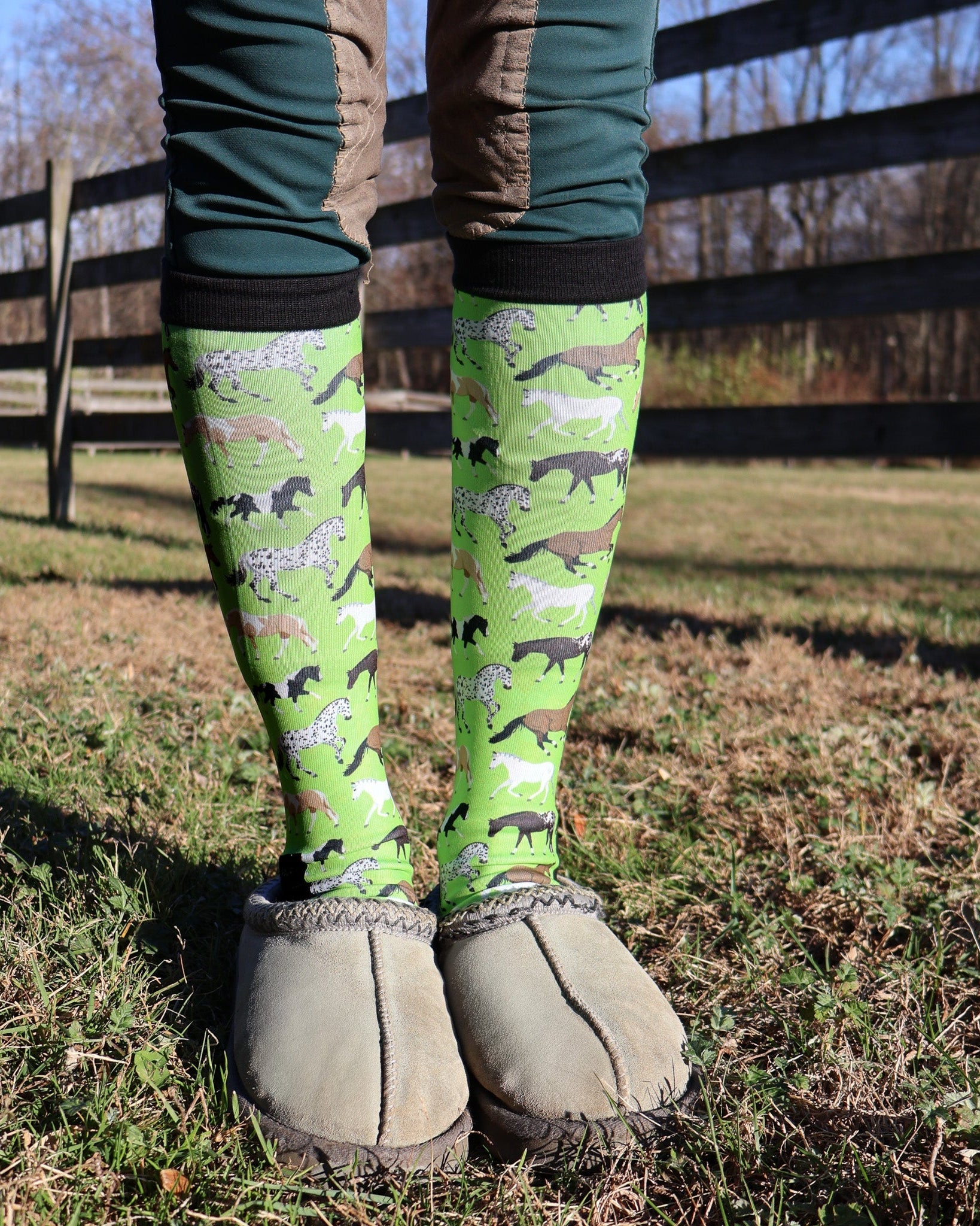 Limited edition neon green Pony Island boot socks with colorful pony patterns, worn outdoors with slippers