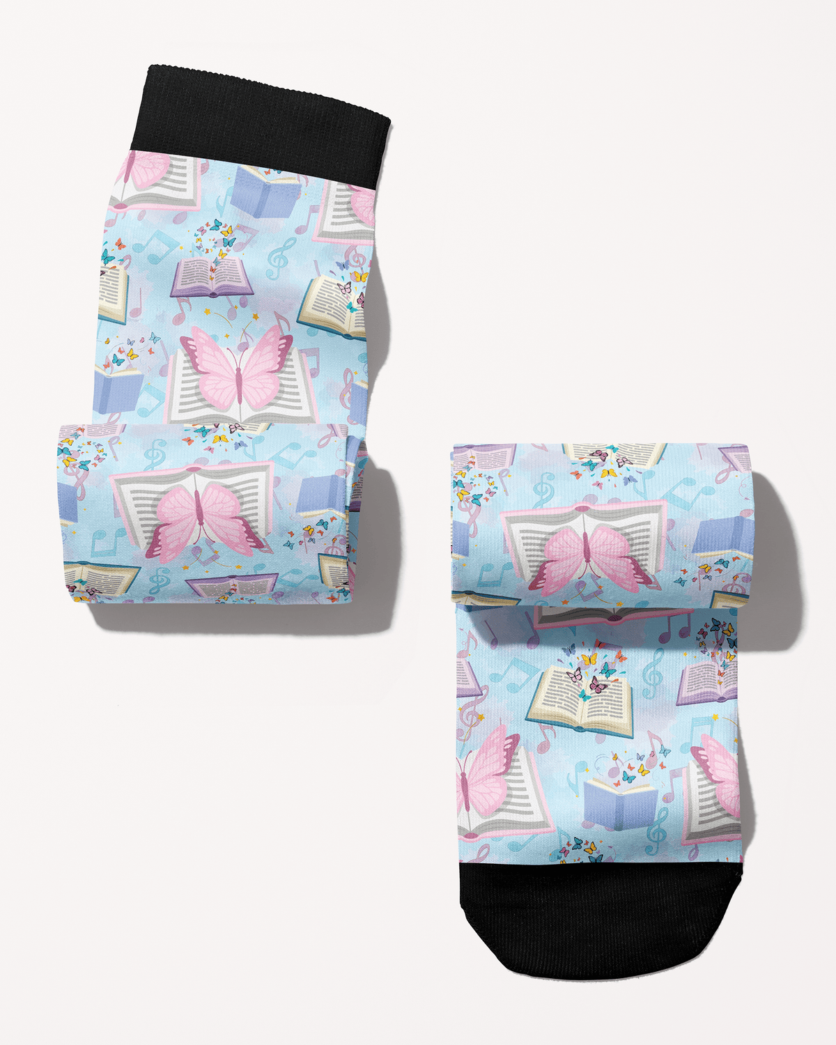 Reading 9-5 boot socks rolled into a pair, pastel blue with open books and butterflies