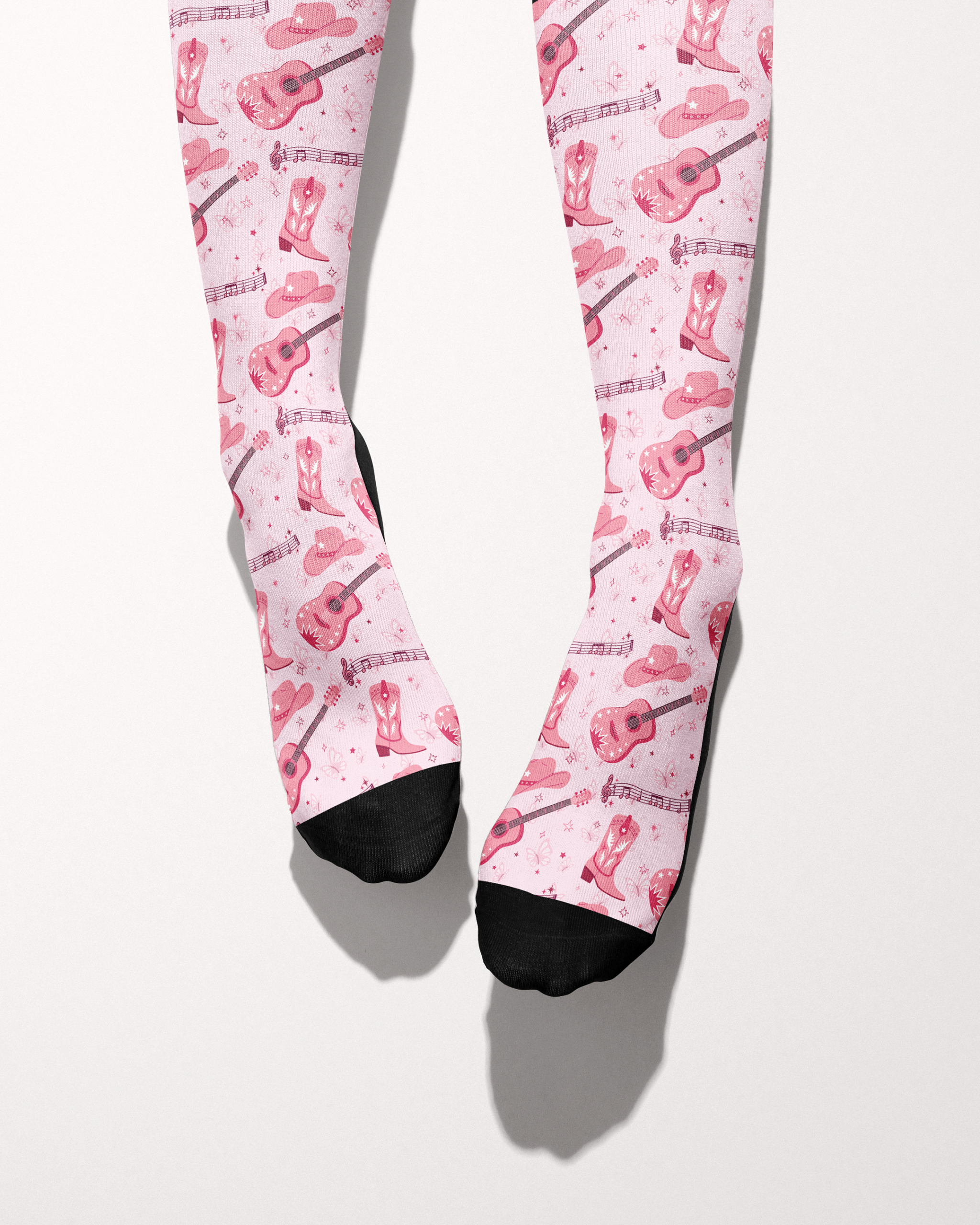 Dolly Forever socks shown on bare feet with black toes, pink cowgirl-themed print