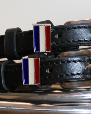 Close-up of red, white and blue Netherlands flag charms on black leather spur straps