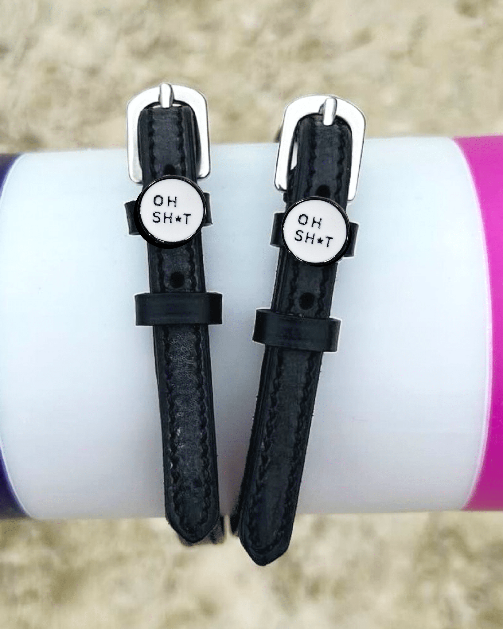 ManeJane OH SH*T spur straps wrapped around a colorful tumbler, lifestyle shot