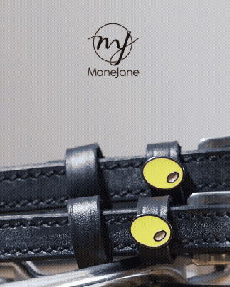 ManeJane branded close-up of olive charms on black leather spur straps with logo