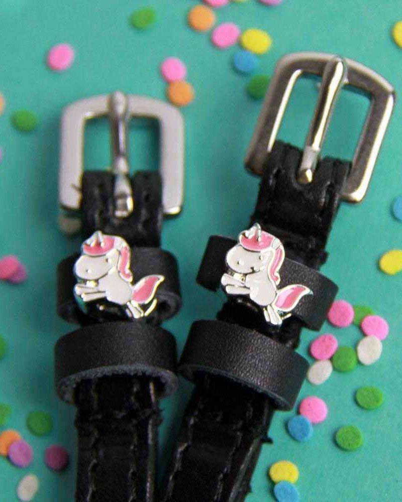 Unicorn charm spur straps with silver buckles on teal with confetti sprinkles