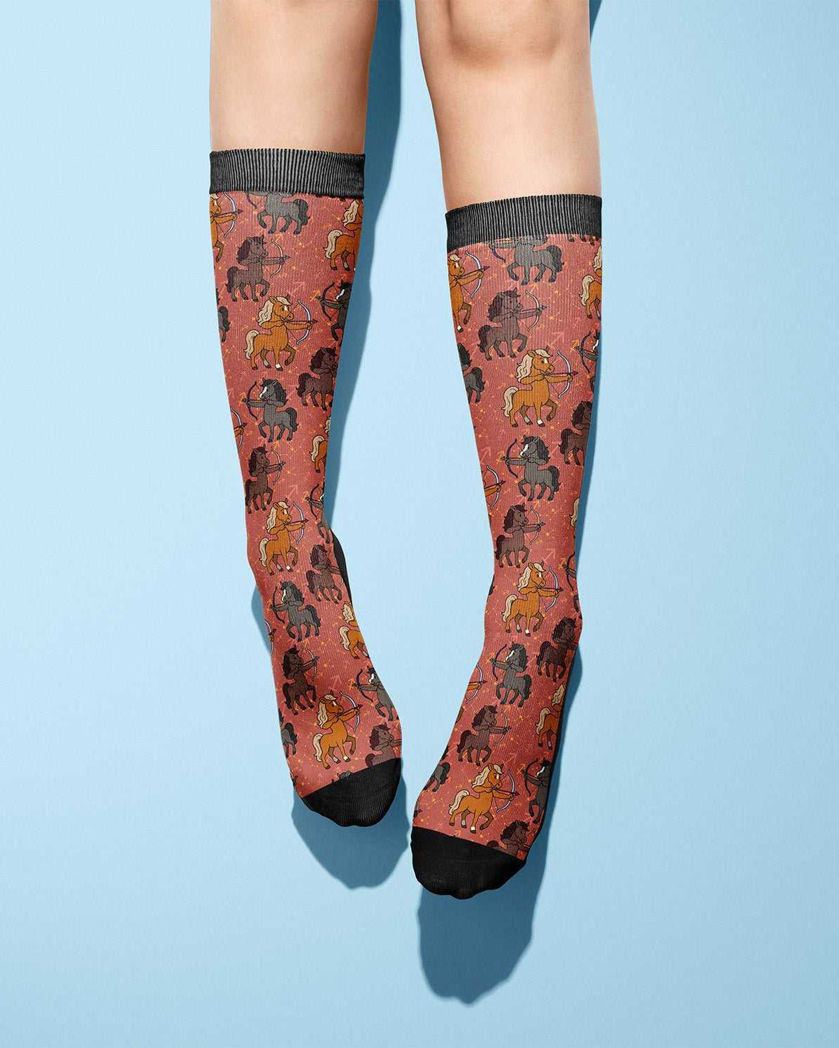 Sagittarius zodiac horseback riding boot socks with horse pattern on rust background