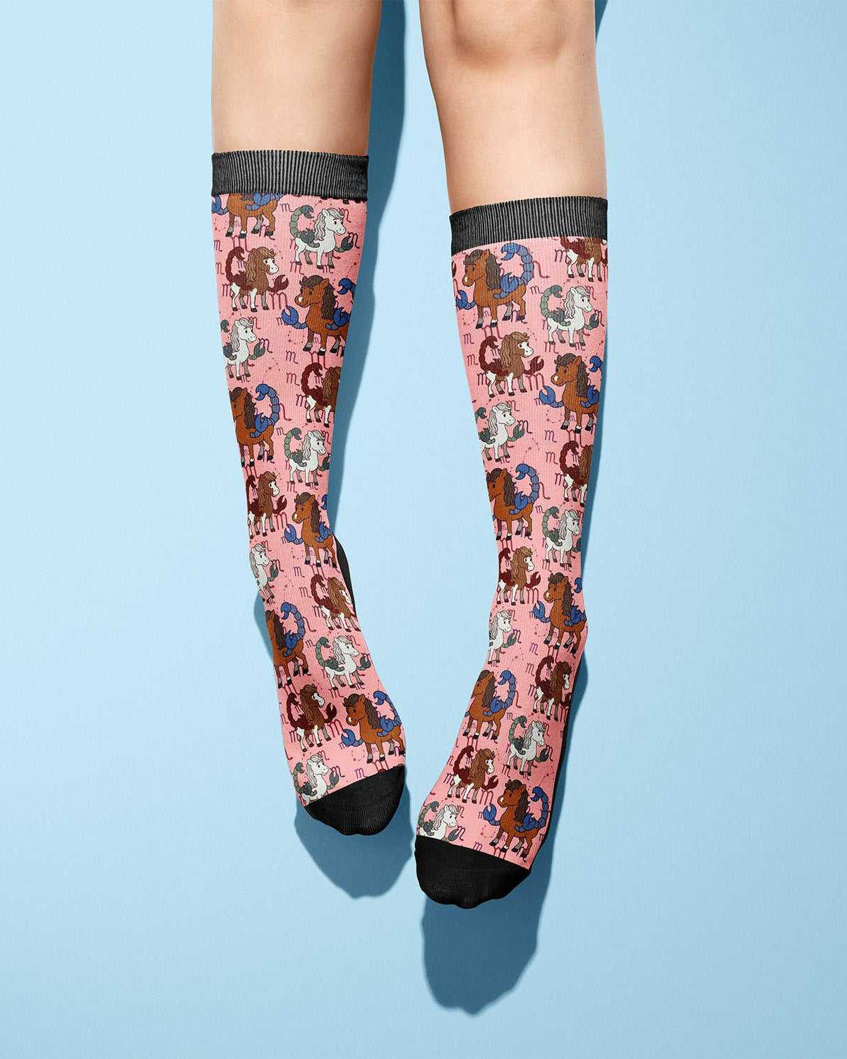 pink riding boot socks with horse pattern and black toes and cuffs