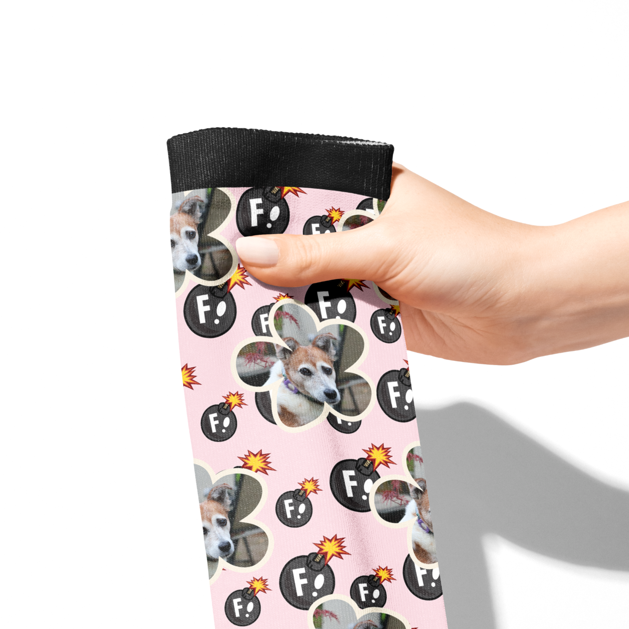 Hand holding custom flower socks with dog photo and F Bombs pattern on pink background