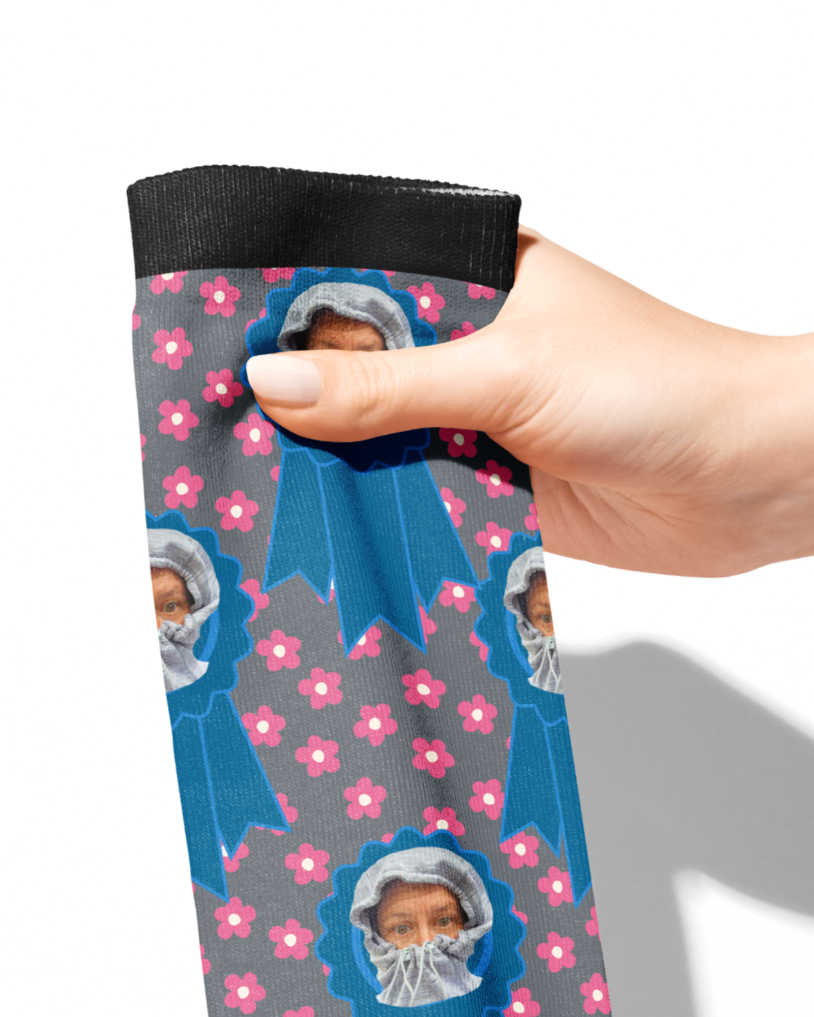 Custom blue ribbon socks with pink petals and personalized photo design held by a hand