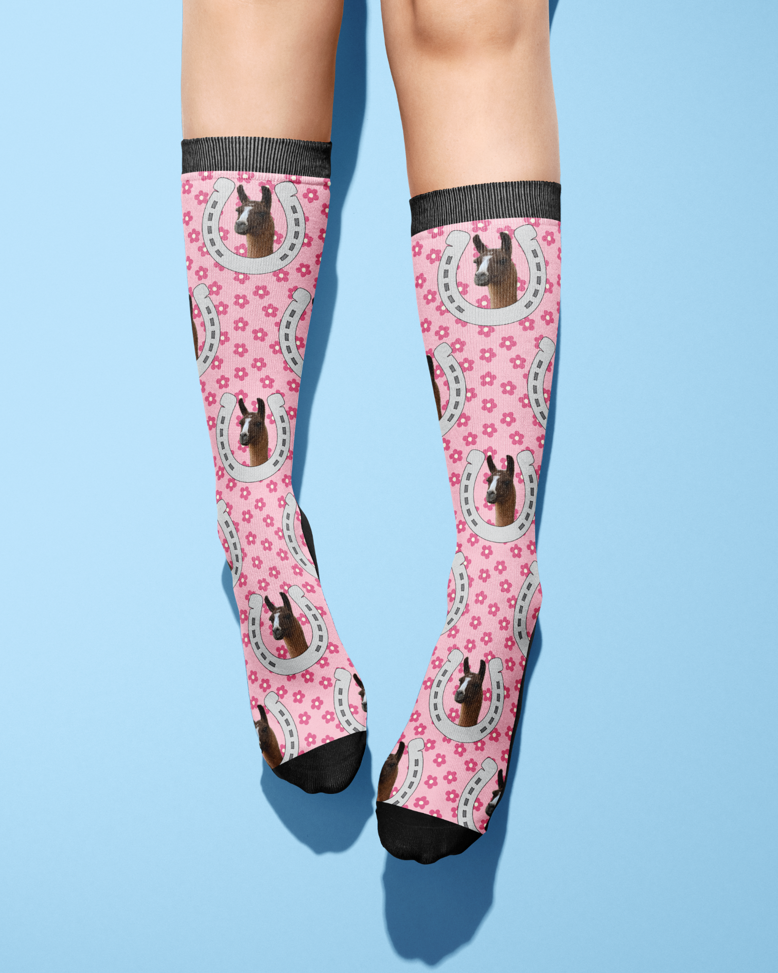 Custom Horseshoe pink socks with horse photo and floral pattern on legs against blue background