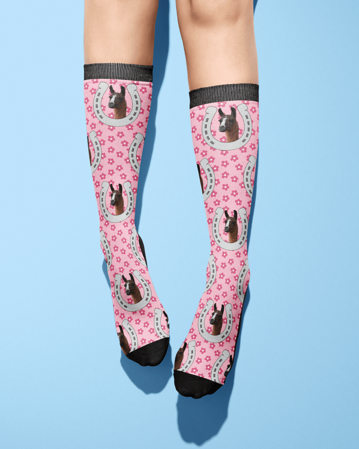 Custom Horseshoe pink socks with horse photo and floral pattern on legs against blue background