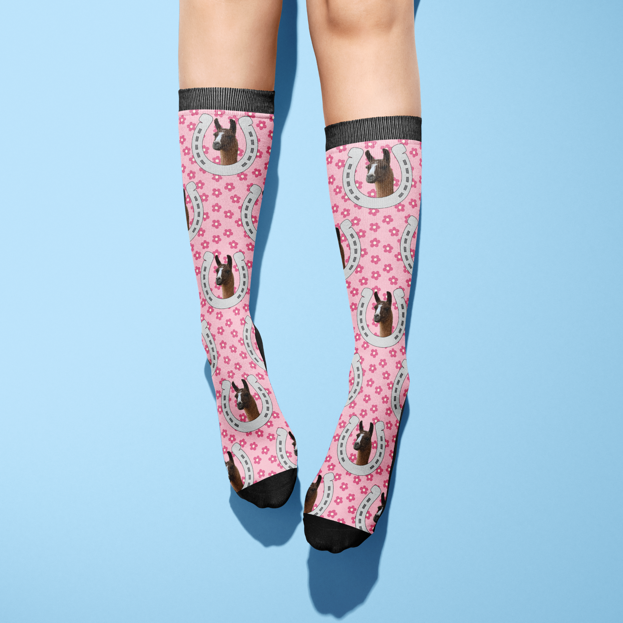 Custom Horseshoe pink socks with horse photo and floral pattern on legs against blue background