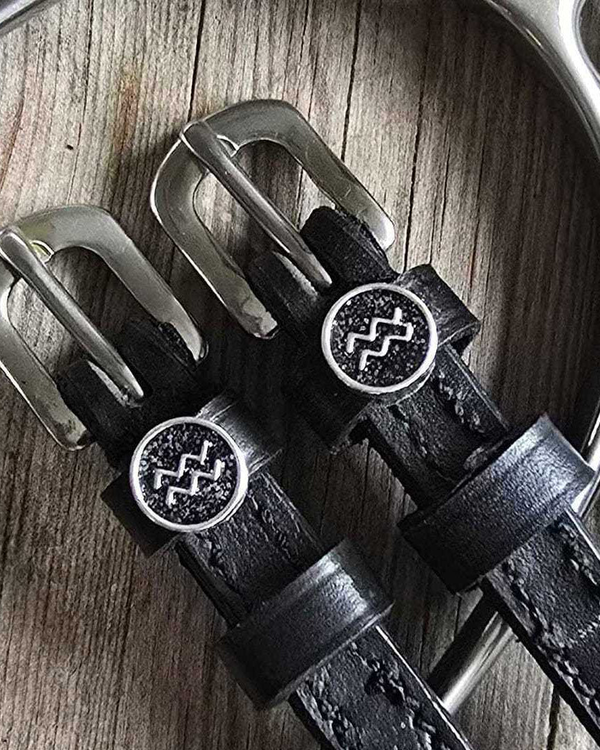 Black leather Aquarius Spur Straps with stainless steel buckles and custom ManeJane charm