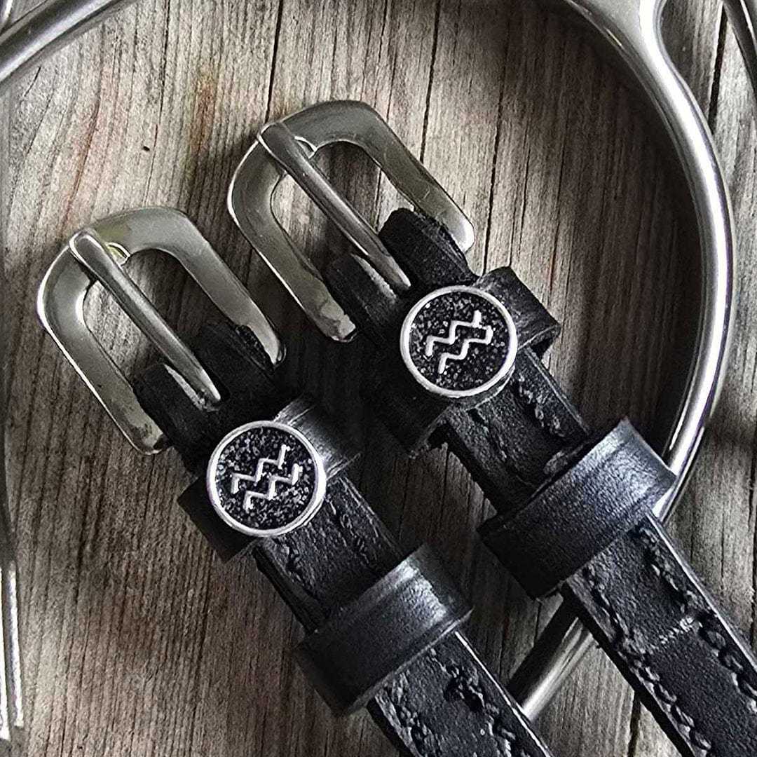 Black leather Aquarius Spur Straps with stainless steel buckles and custom ManeJane charm