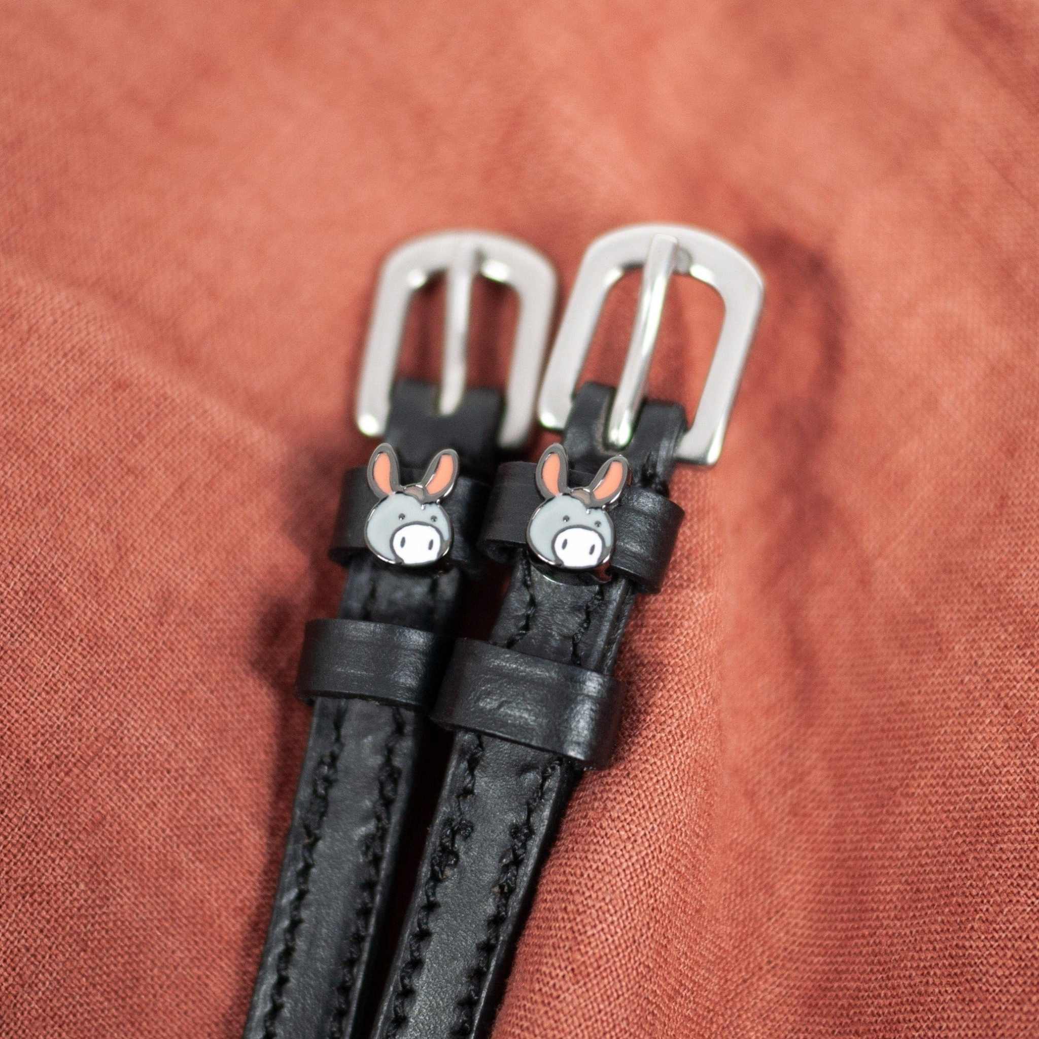 Donkey Spur Strap ManeJane black leather spur straps with non-stretch interior and stainless steel buckle for English ridin.