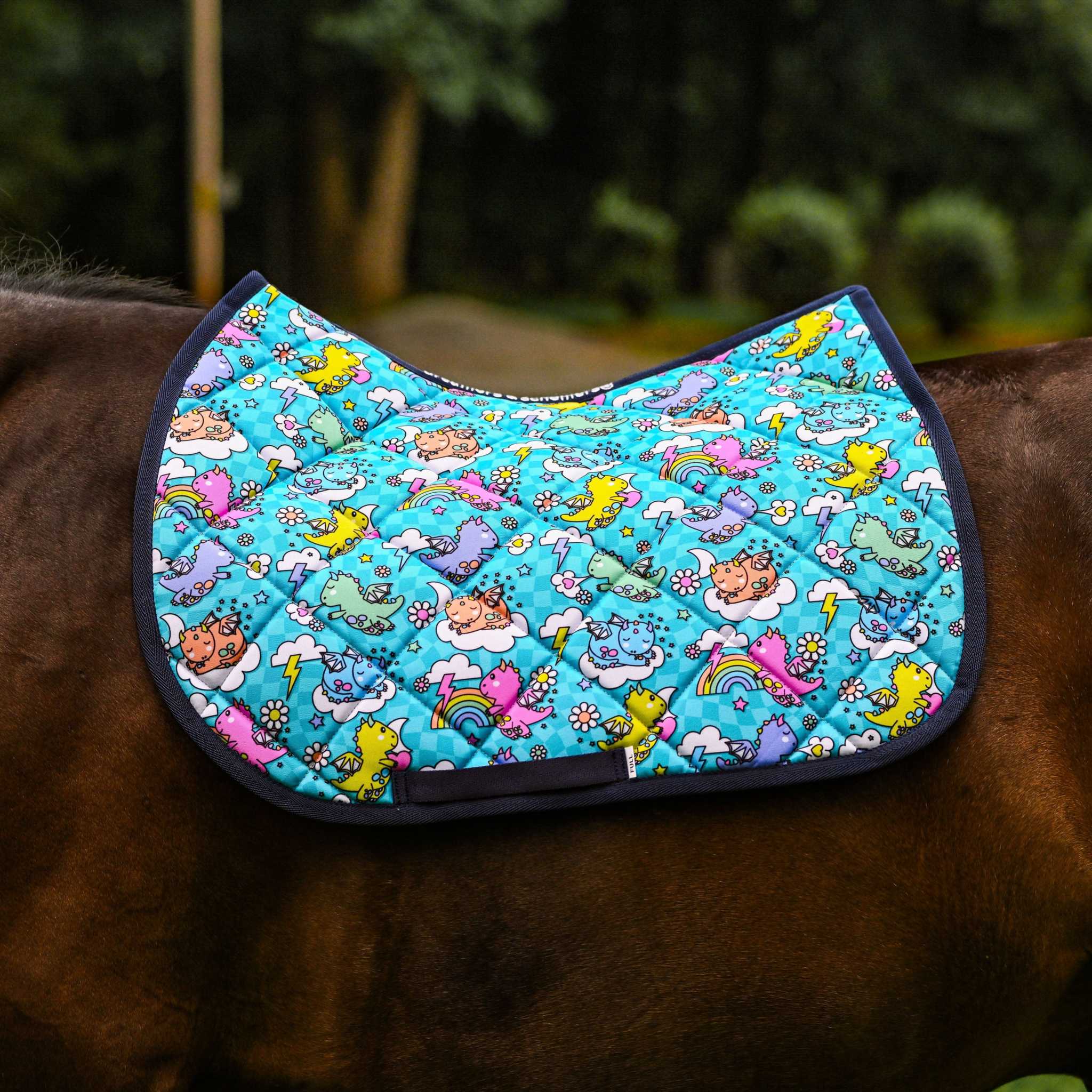 Colorful Dragon Dreams Bundle saddle pad with vibrant dragon and fantasy-themed designs on a horse's back