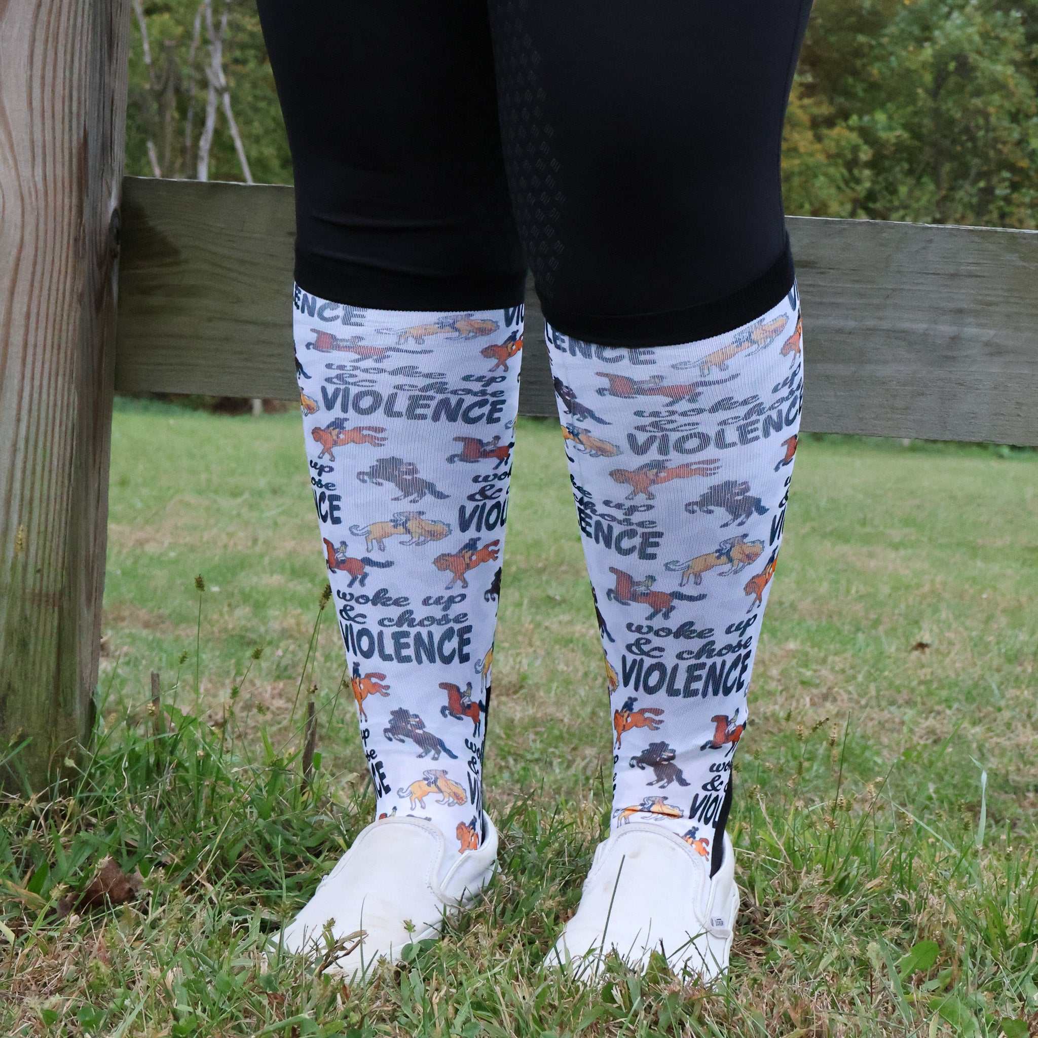 Limited edition "Woke Up, Chose Violence" boot socks with bold print worn outdoors