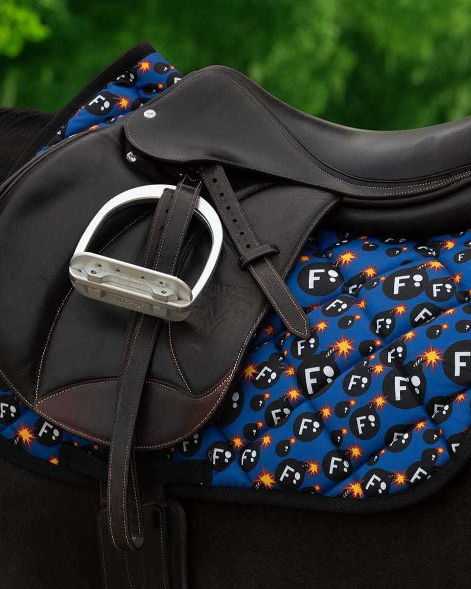 Ultimate F-Bomb Pack dressage saddle pad with black leather saddle and stirrup on horse
