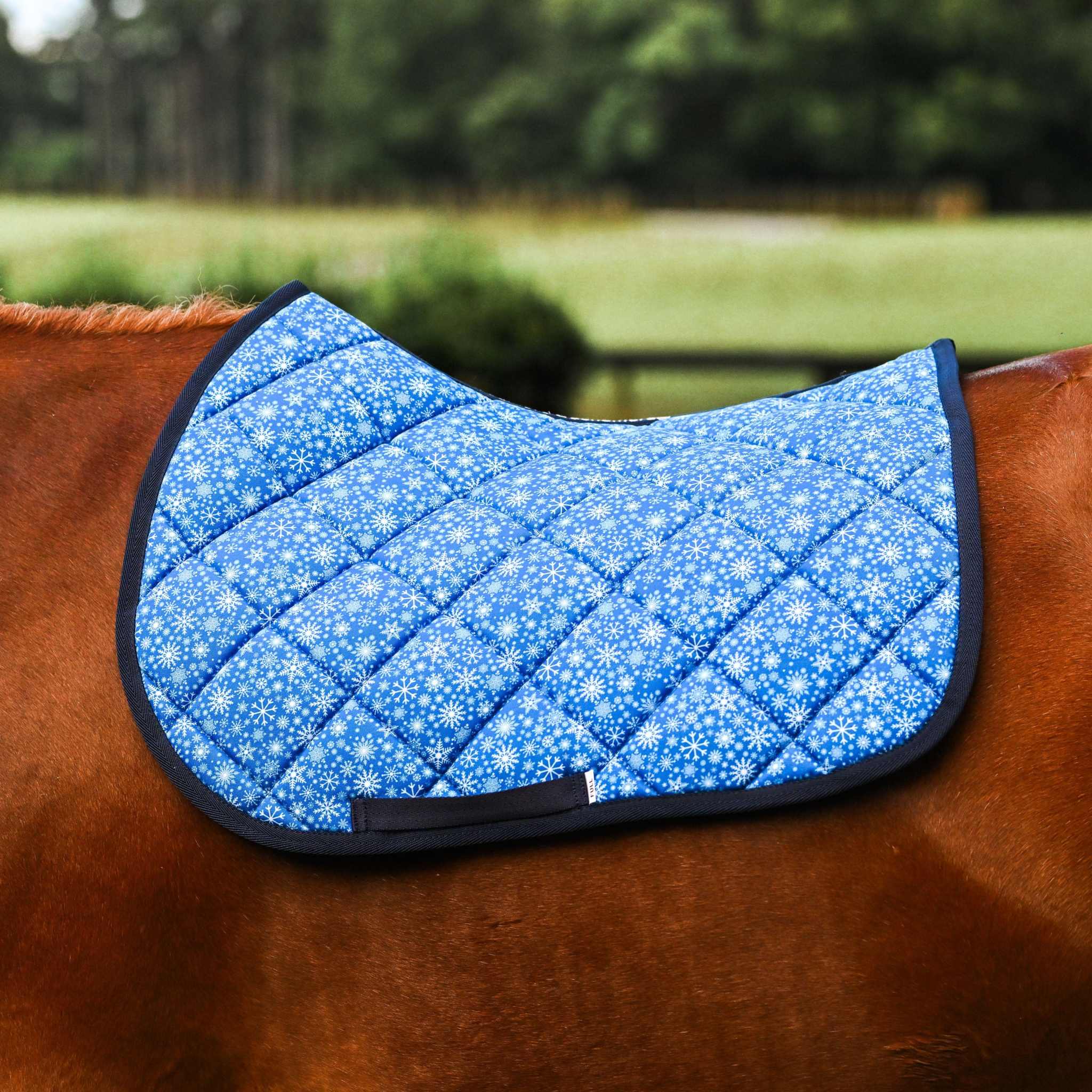 Blue Flake It til You Make It quilted saddle pad on brown horse back