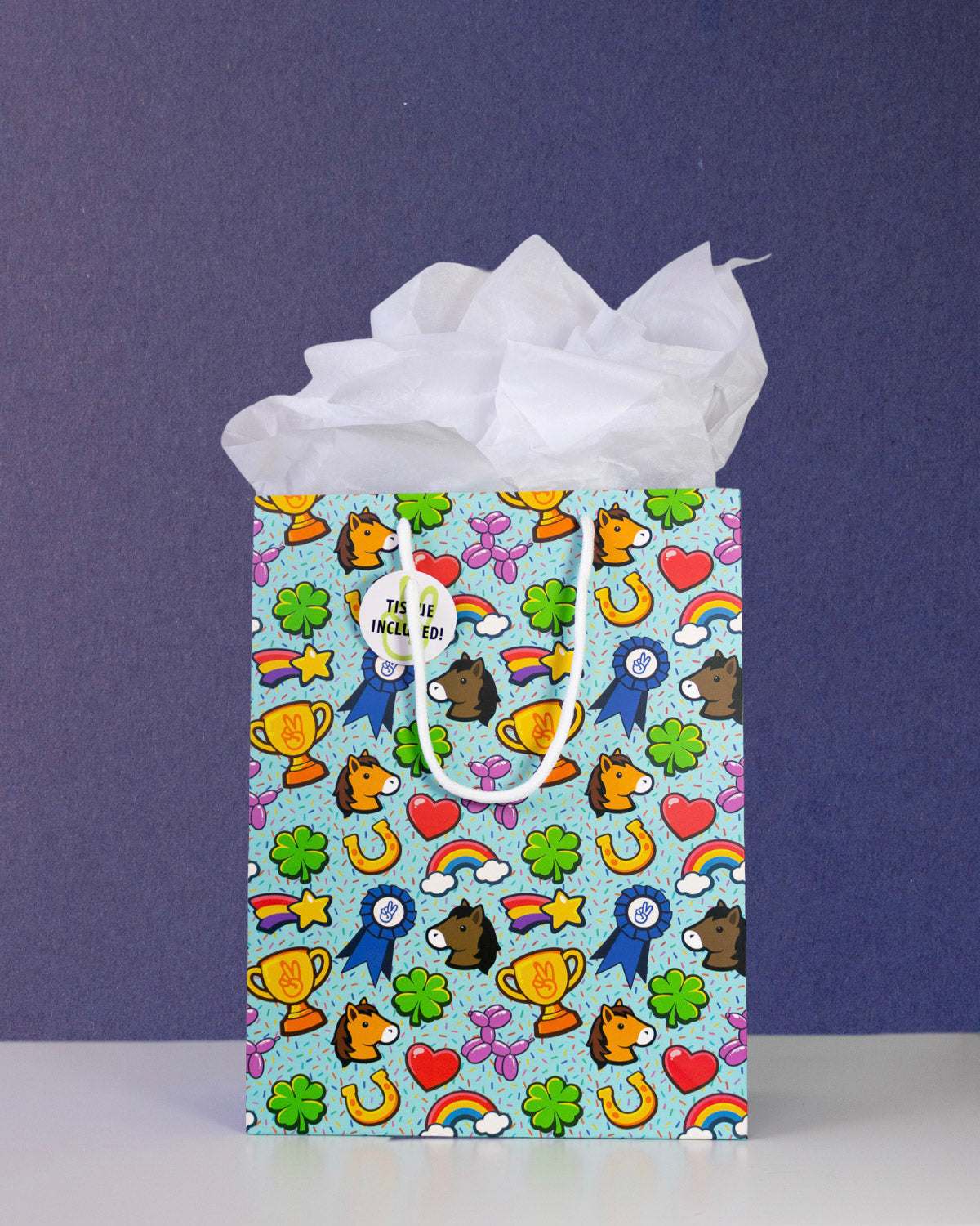 Full O' Luck medium gift bag front-on against navy, tissue paper puffed above the pale aqua print.
