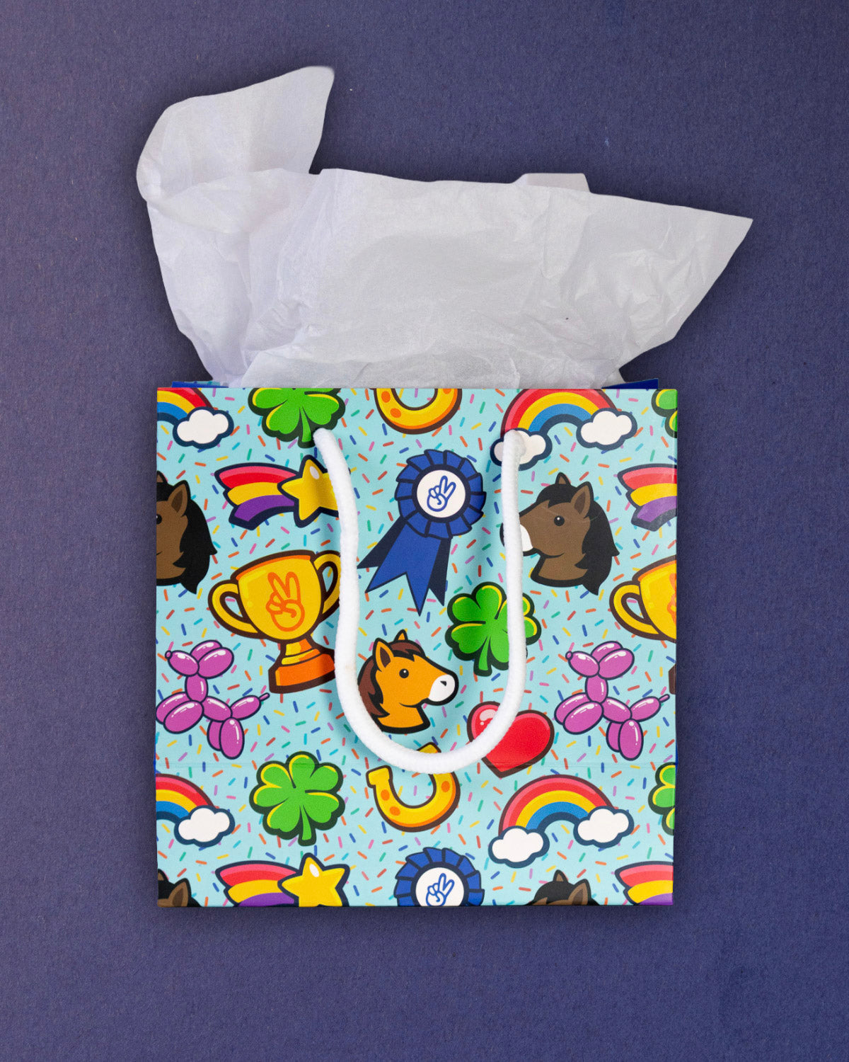 Full O' Luck small gift bag front-on, square aqua panel of horseshoes, hearts and balloon ponies.