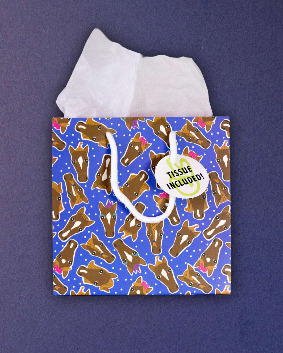 Hairy Styles small gift bag standing front-on, tissue paper above a square panel of horse heads.