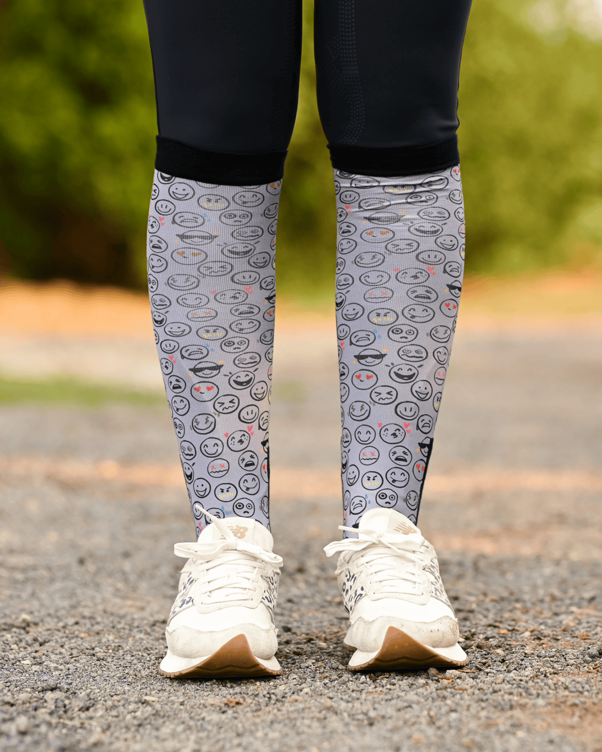 Horse Ownership equestrian boot socks worn at the barn, soft grey with the emoji faces of horse ownership