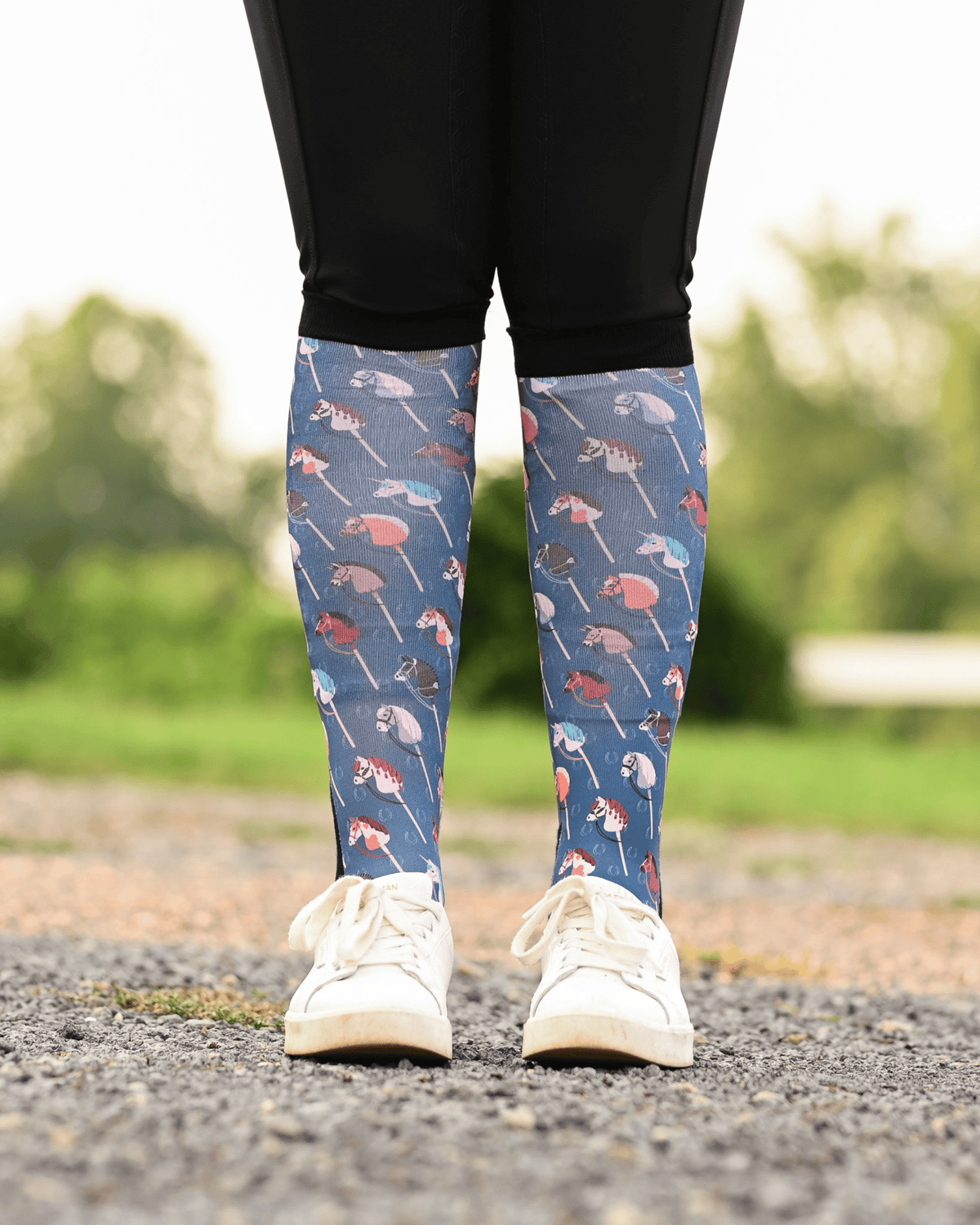 It's Not a Hobby equestrian boot socks worn at the barn, slate blue with hobby horses on wooden sticks