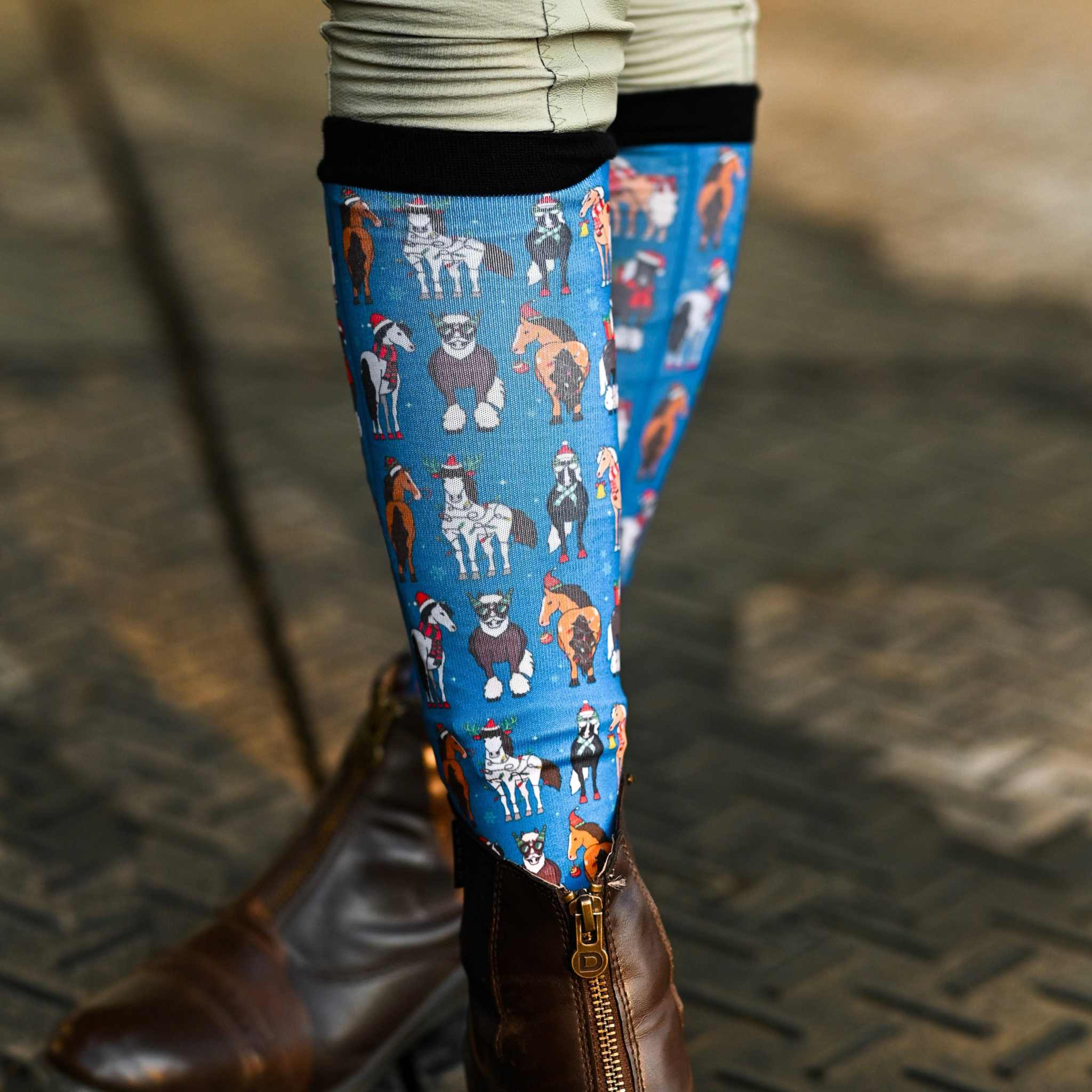 Youth holiday-themed riding boot socks with animal designs and black stretchy tops