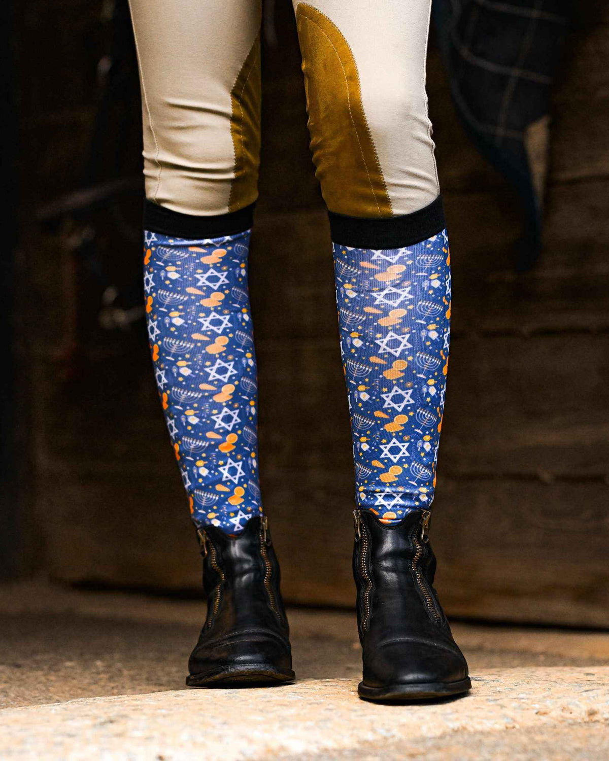 Blue Keep Calm & Dreidel On riding socks with Hanukkah symbols worn with black riding boots